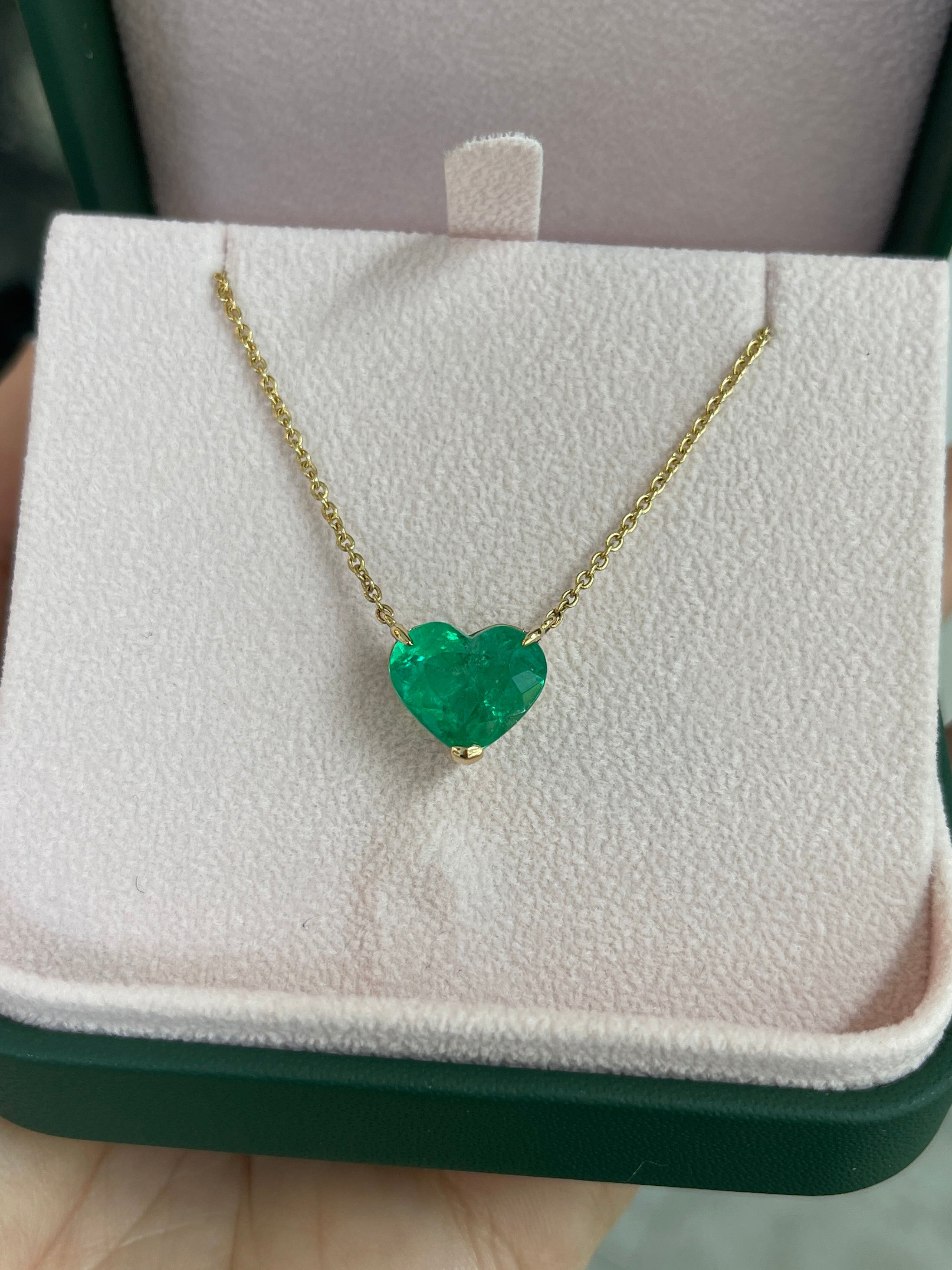 Colombian emerald heart-cut solitaire necklace with 18K gold setting from JR Colombian Emeralds, showcasing a vibrant green gemstone.