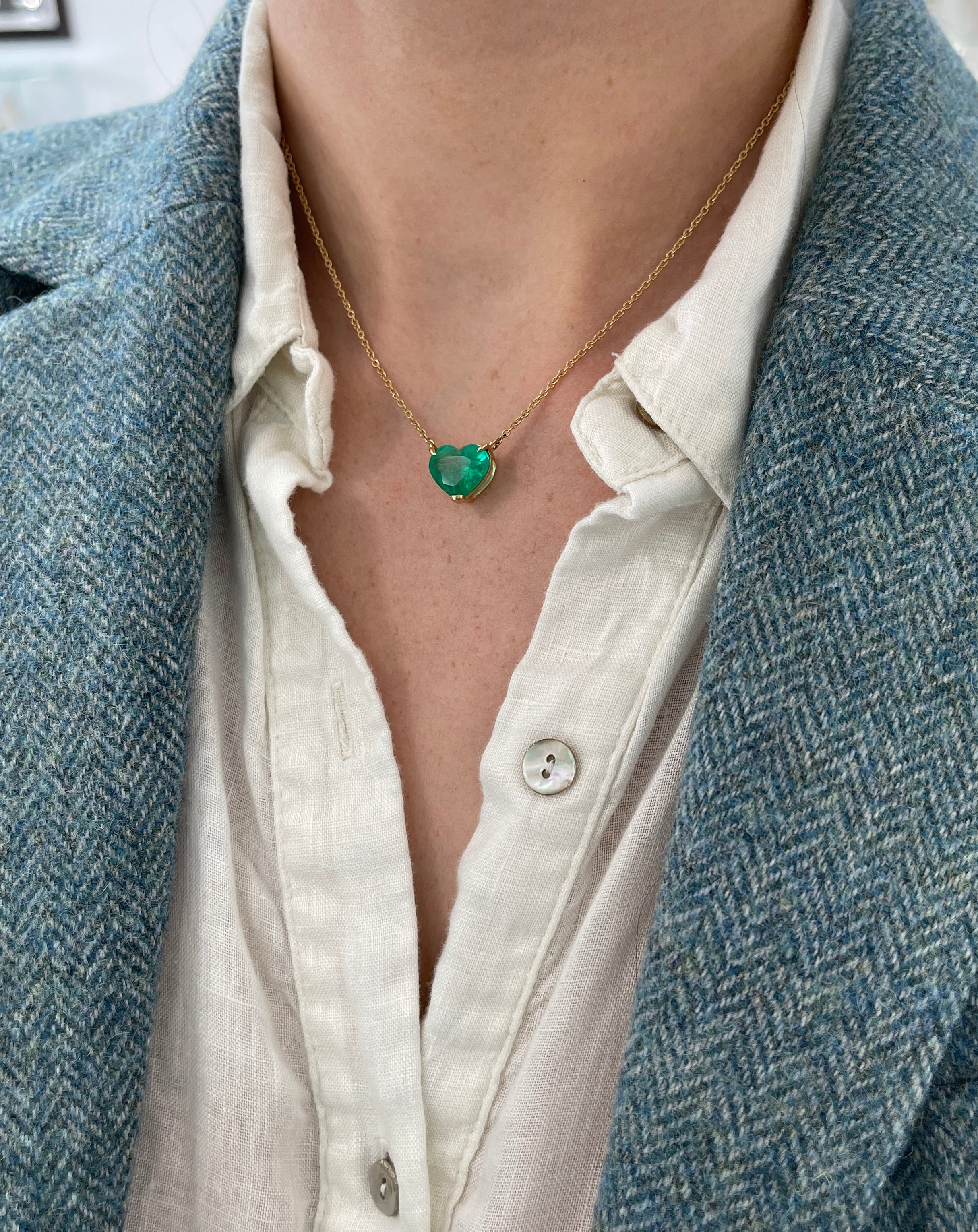 Colombian emerald heart-cut solitaire necklace with 18K gold chain, featuring a 5.77-carat vivid green gemstone by JR Colombian Emeralds