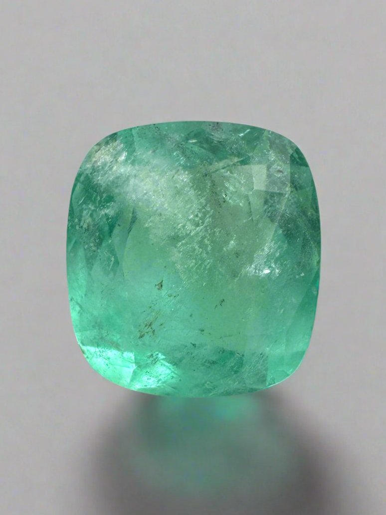 5.86 carat natural Colombian emerald loose cushion cut with earthy pastel green color, from JR Colombian Emeralds.