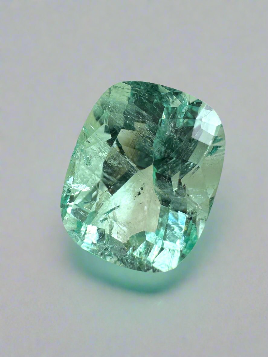 Seafoam green 5.96-carat elongated cushion cut Colombian emerald with natural freckles, loose gemstone from JR Colombian Emeralds.