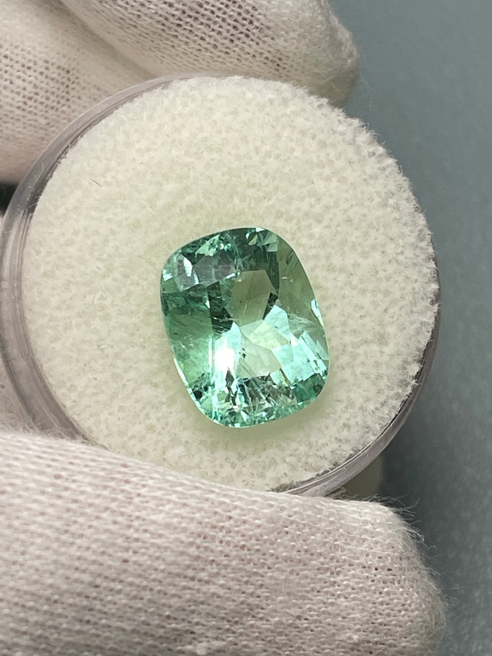 Seafoam green 5.96 carat Colombian emerald loose gemstone, elongated cushion cut with natural freckles, by JR Colombian Emeralds.
