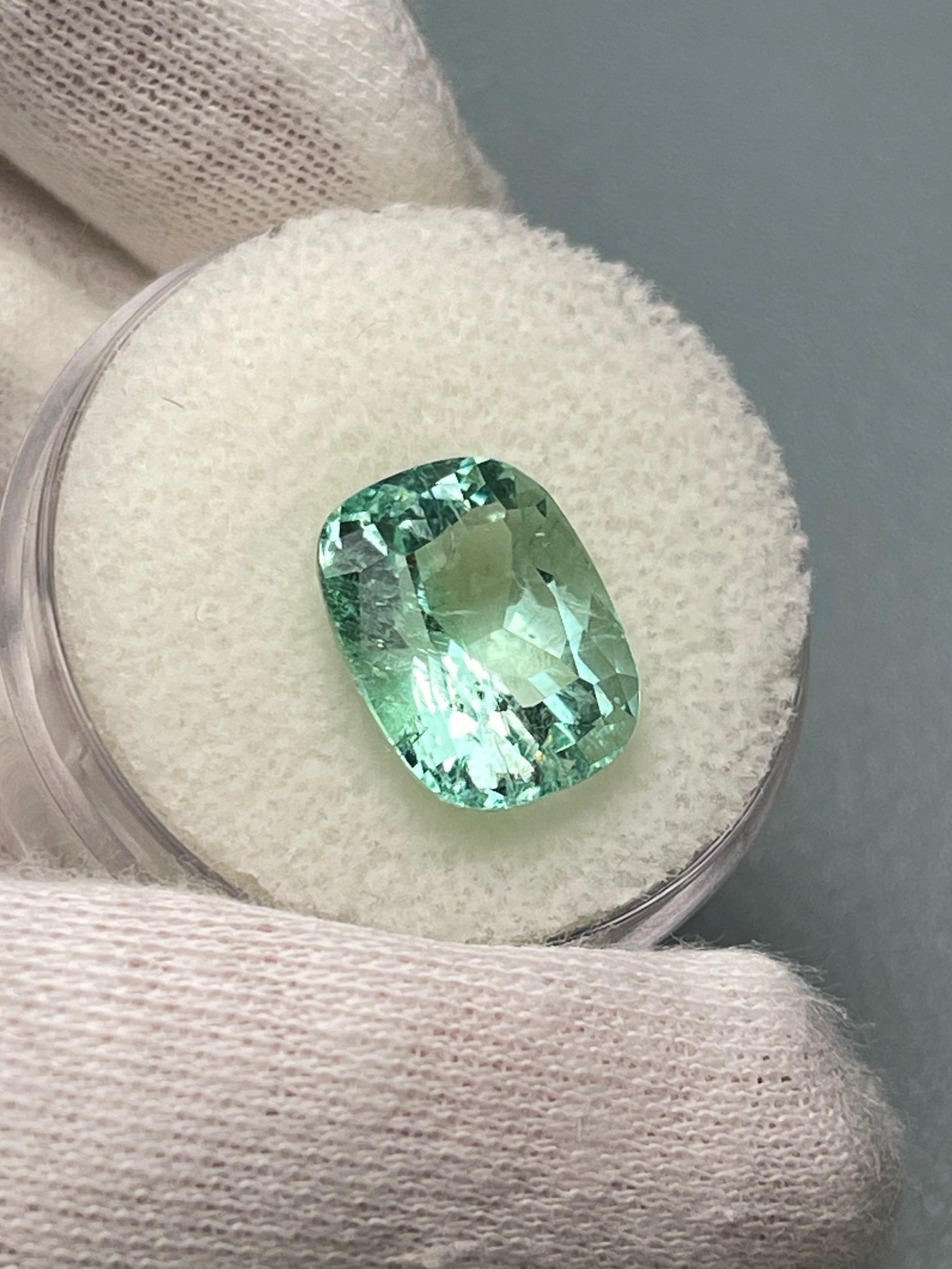 Seafoam green 5.96 carat natural Colombian emerald loose cushion cut with freckles, from JR Colombian Emeralds.