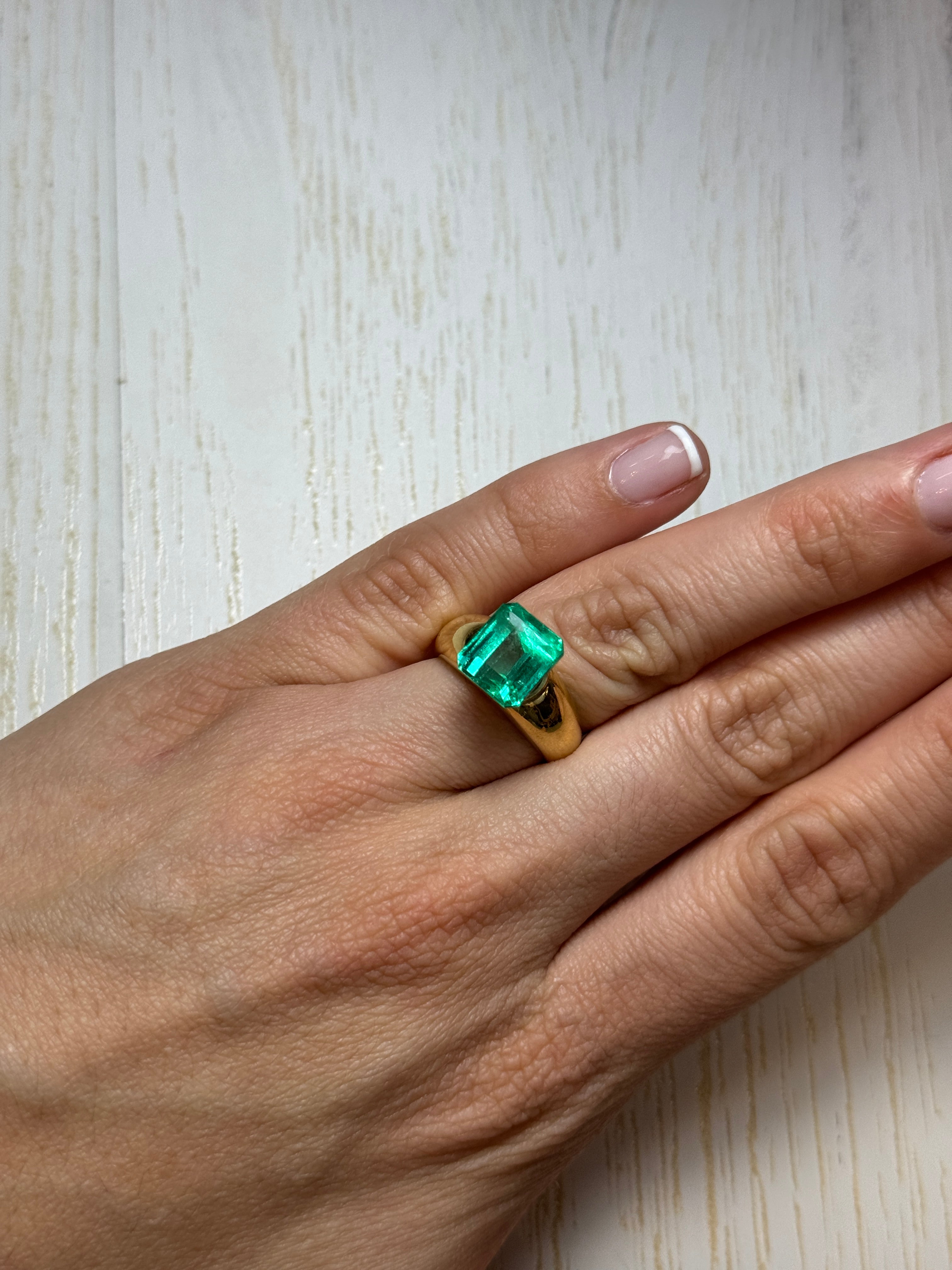 Loose 5.98 carat Colombian emerald cut emerald from JR Colombian Emeralds, vibrant green, crystal-clear, natural gemstone.