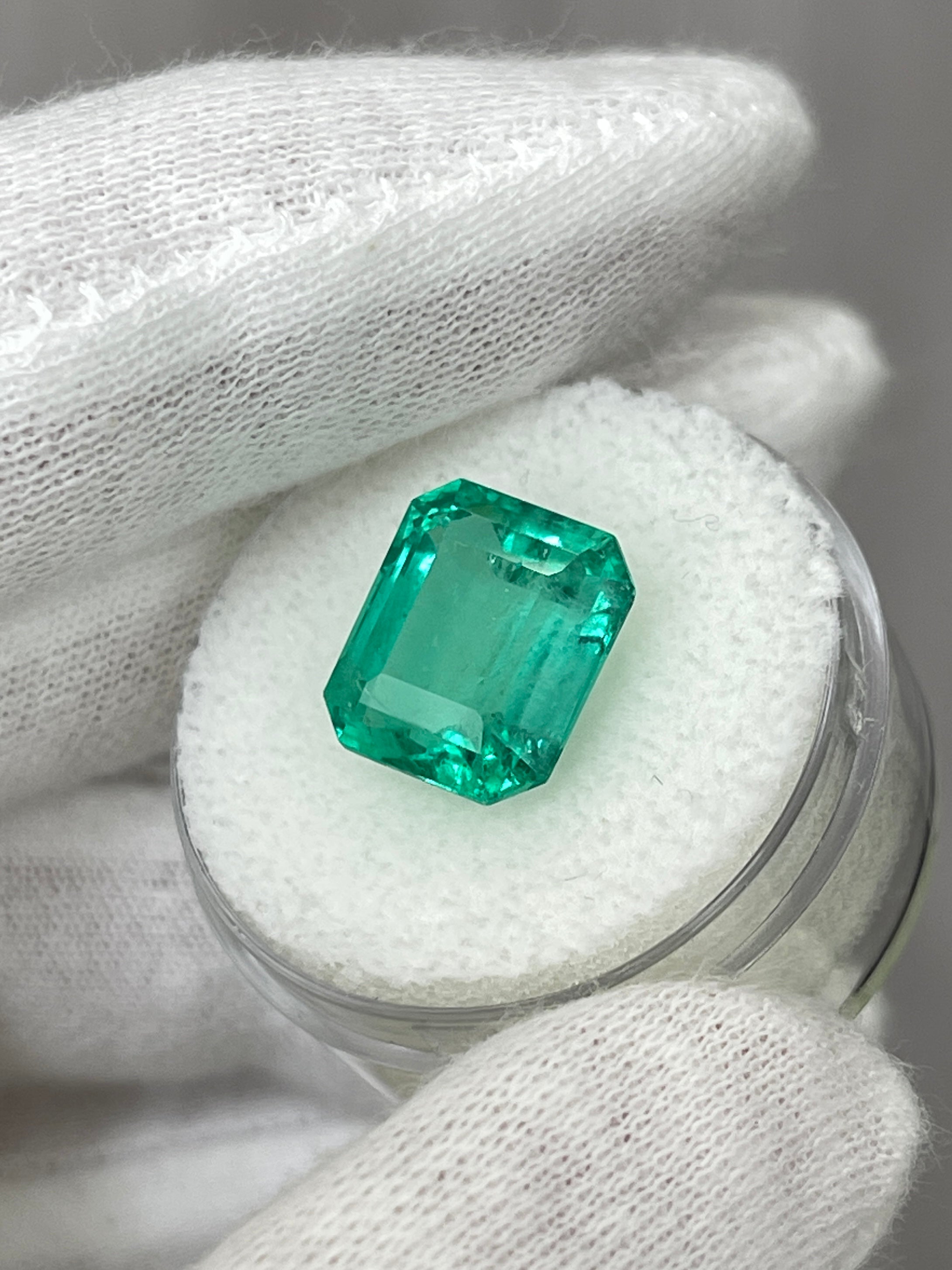 6.03 carat bluish natural Colombian emerald loose gemstone in classic emerald cut, displayed by JR Colombian Emeralds.