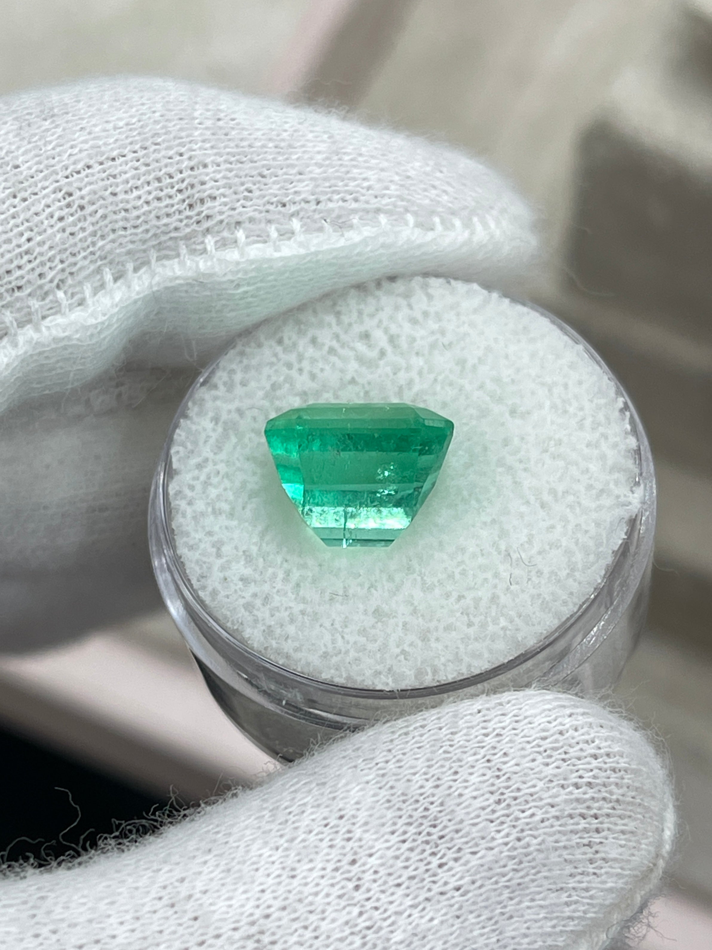 6.07 carat natural loose Colombian emerald with yellowish green color in an Asscher cut, showcasing clarity and vibrant hue.
