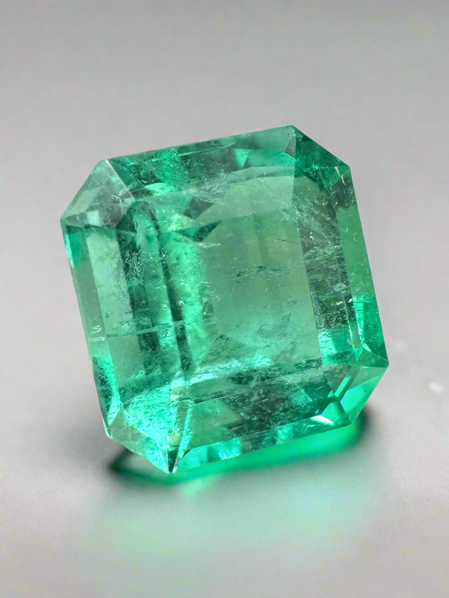 6.07 carat yellowish green natural Colombian emerald loose gemstone in Asscher cut, showcasing vibrant color and clarity.