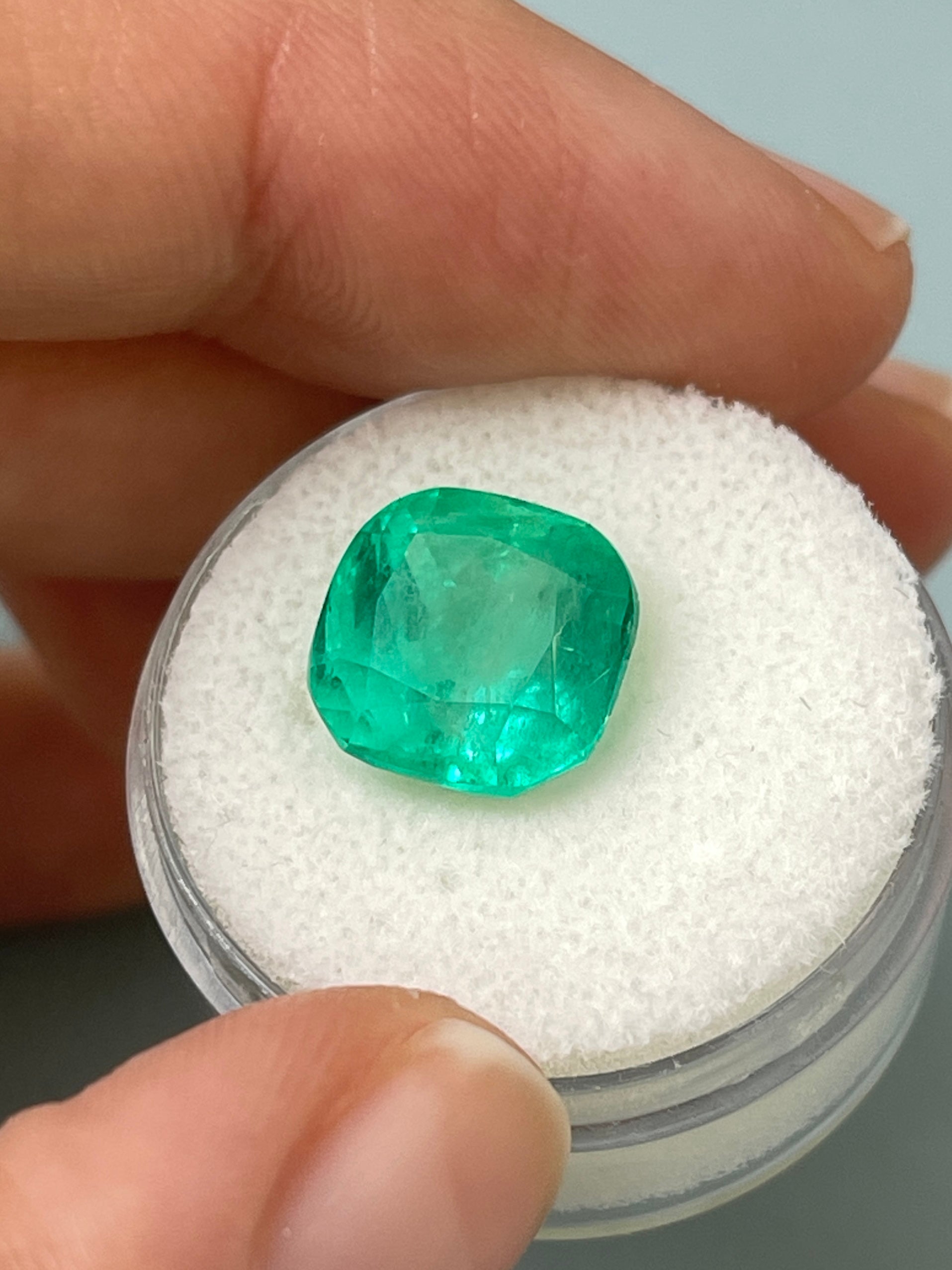 6.25 carat bluish green natural Colombian emerald loose cushion cut gemstone with vibrant color and clarity.