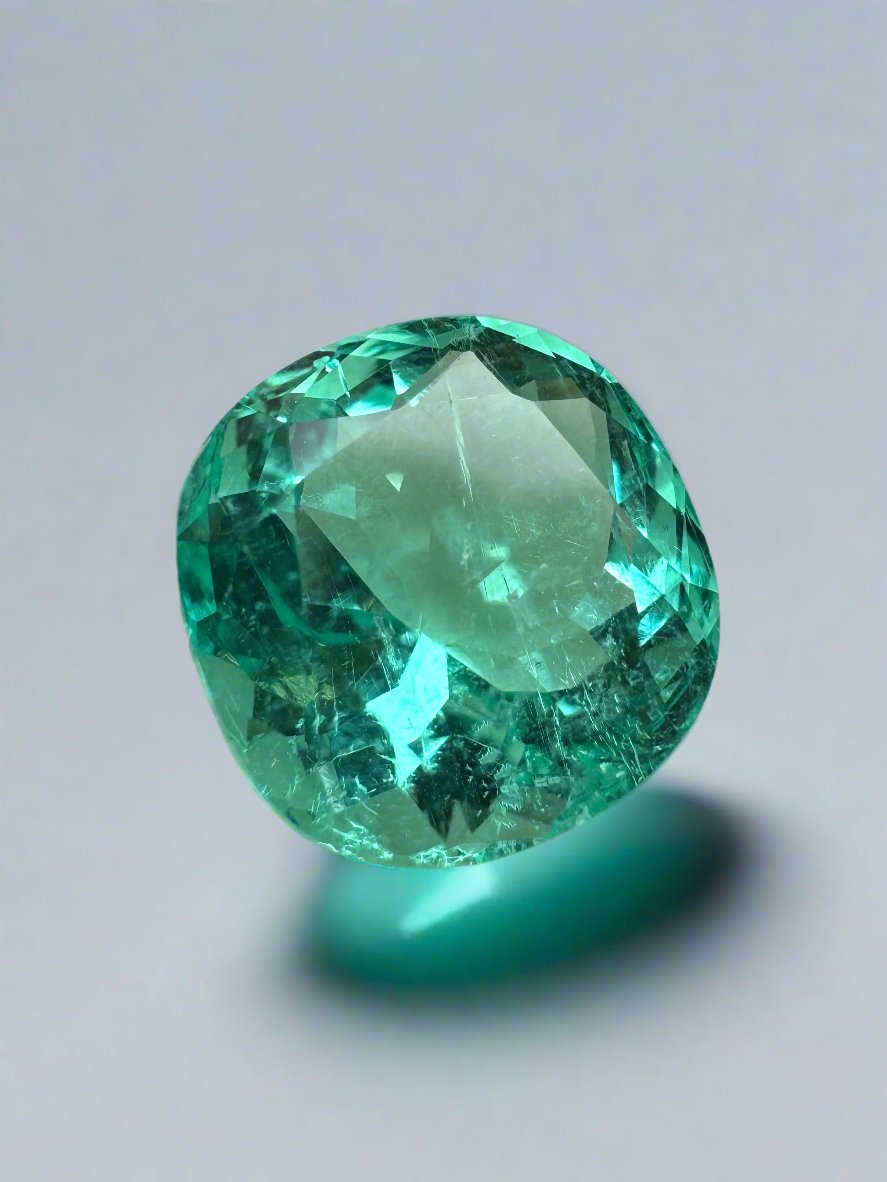 Luminous bluish-green 6.38 carat cushion cut Colombian emerald loose gemstone from JR Colombian Emeralds.
