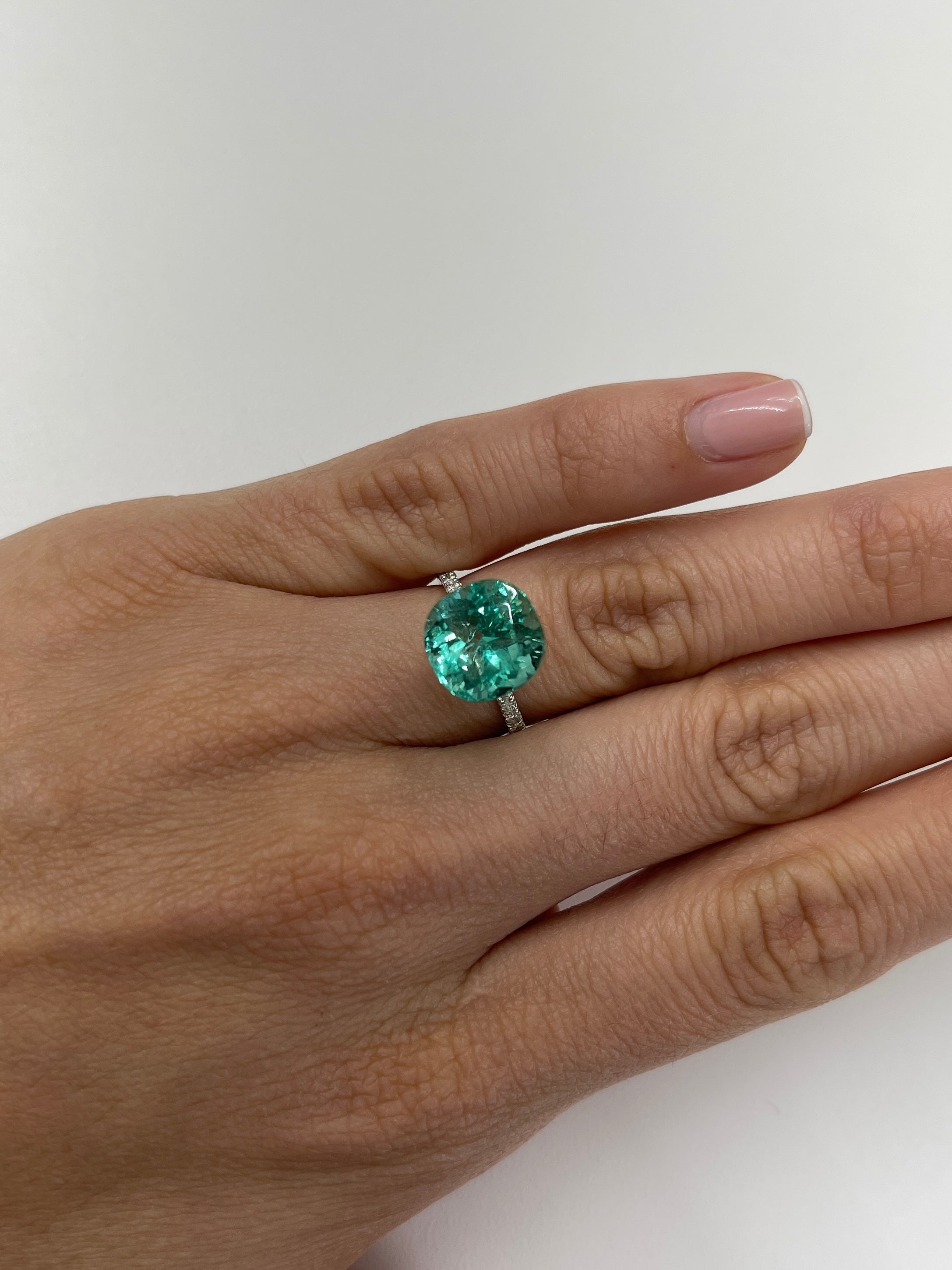 Luminous bluish green 6.38 carat natural Colombian emerald in cushion cut, loose gemstone, with vibrant color and clarity.