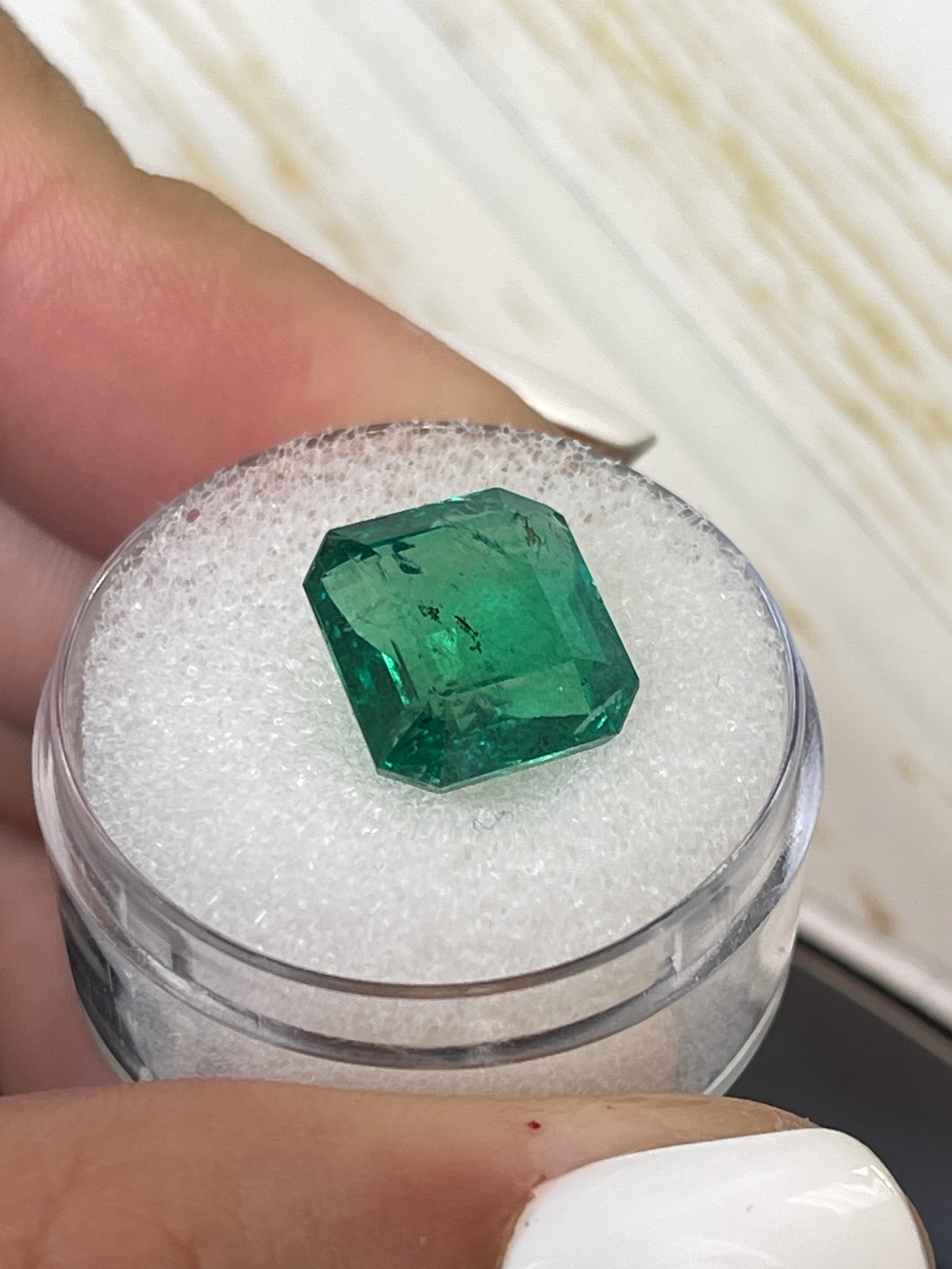 6.54 carat medium deep green natural Zambian emerald cut loose emerald from JR Colombian Emeralds, showcasing vibrant green color.