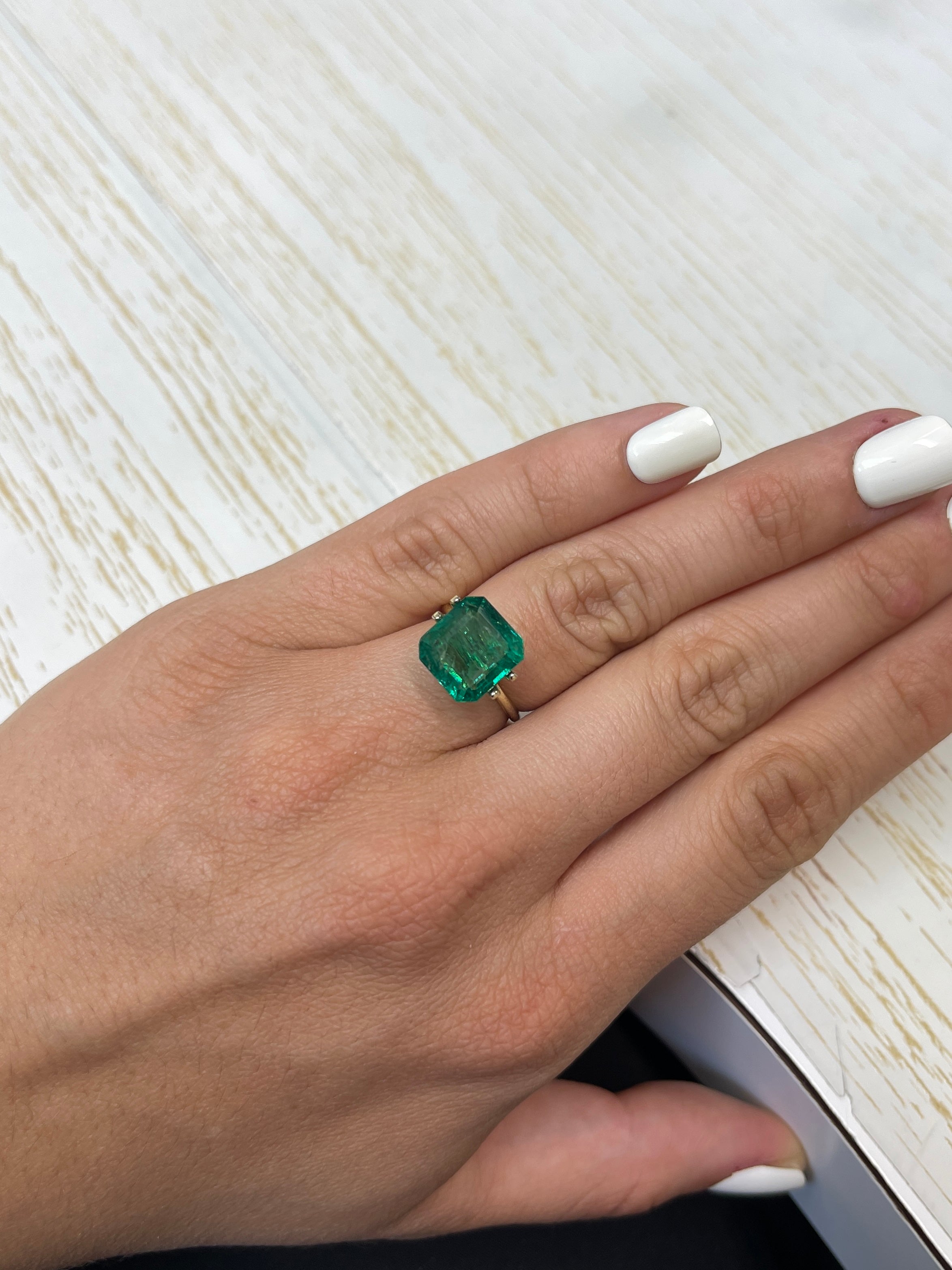 6.54 carat medium deep green Zambian emerald cut loose gemstone from JR Colombian Emeralds, natural and vibrant.