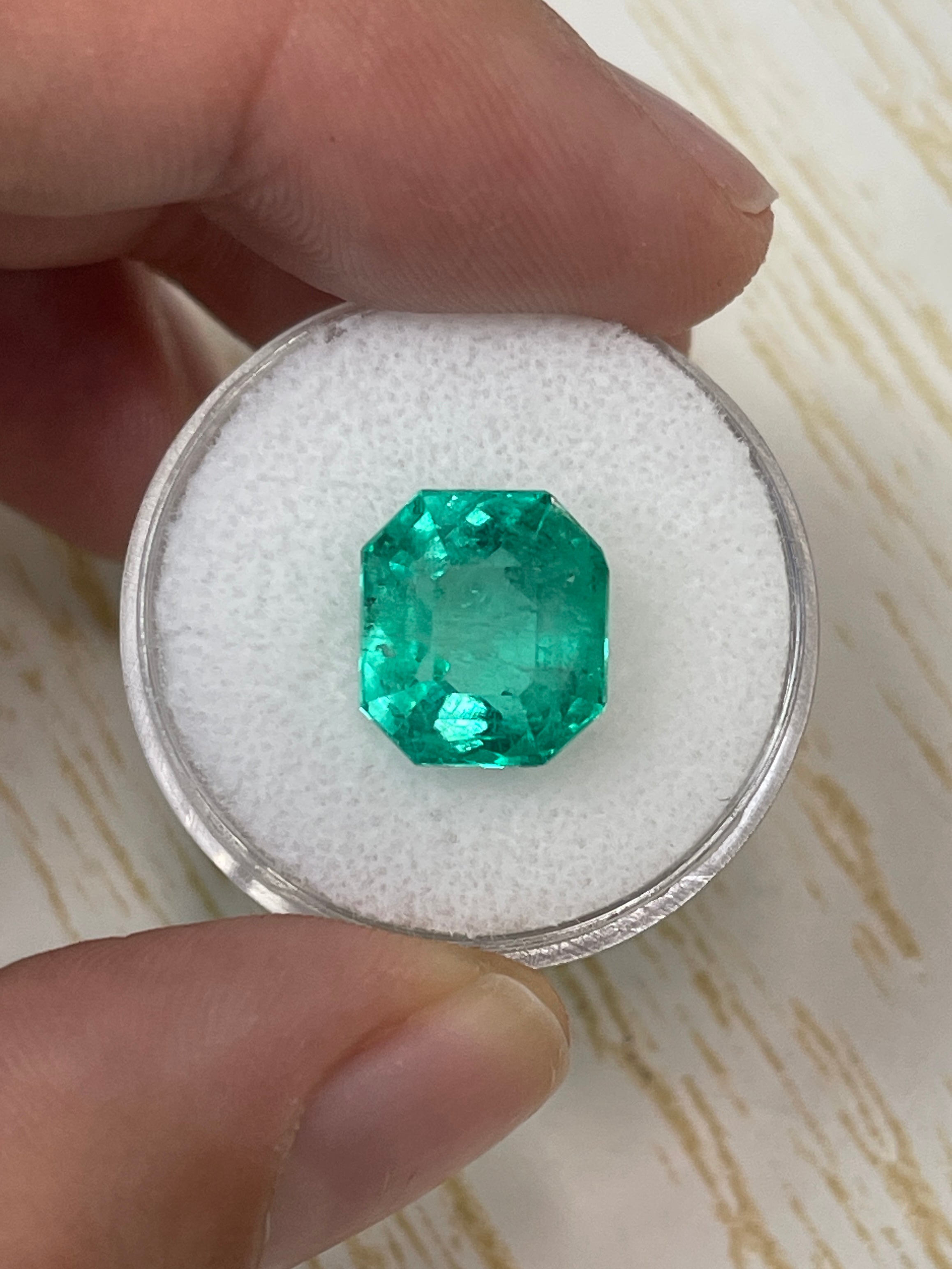6.63 carat natural Colombian emerald loose gemstone with an 11x10mm chunky emerald cut, displayed by JR Colombian Emeralds
