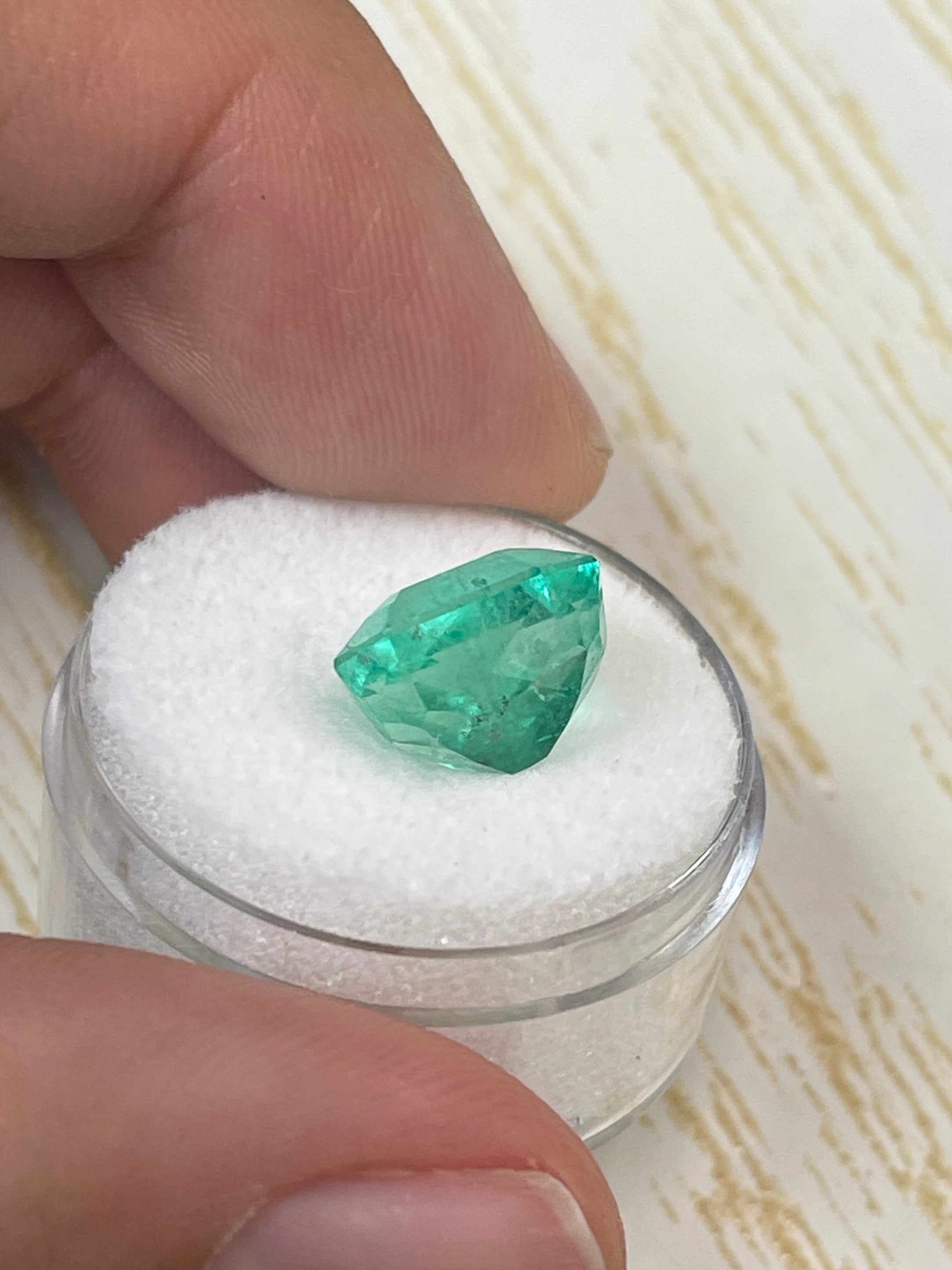 Natural 6.63 carat 11x10mm chunky emerald cut Colombian emerald from JR Colombian Emeralds, loose gemstone with vibrant green color.