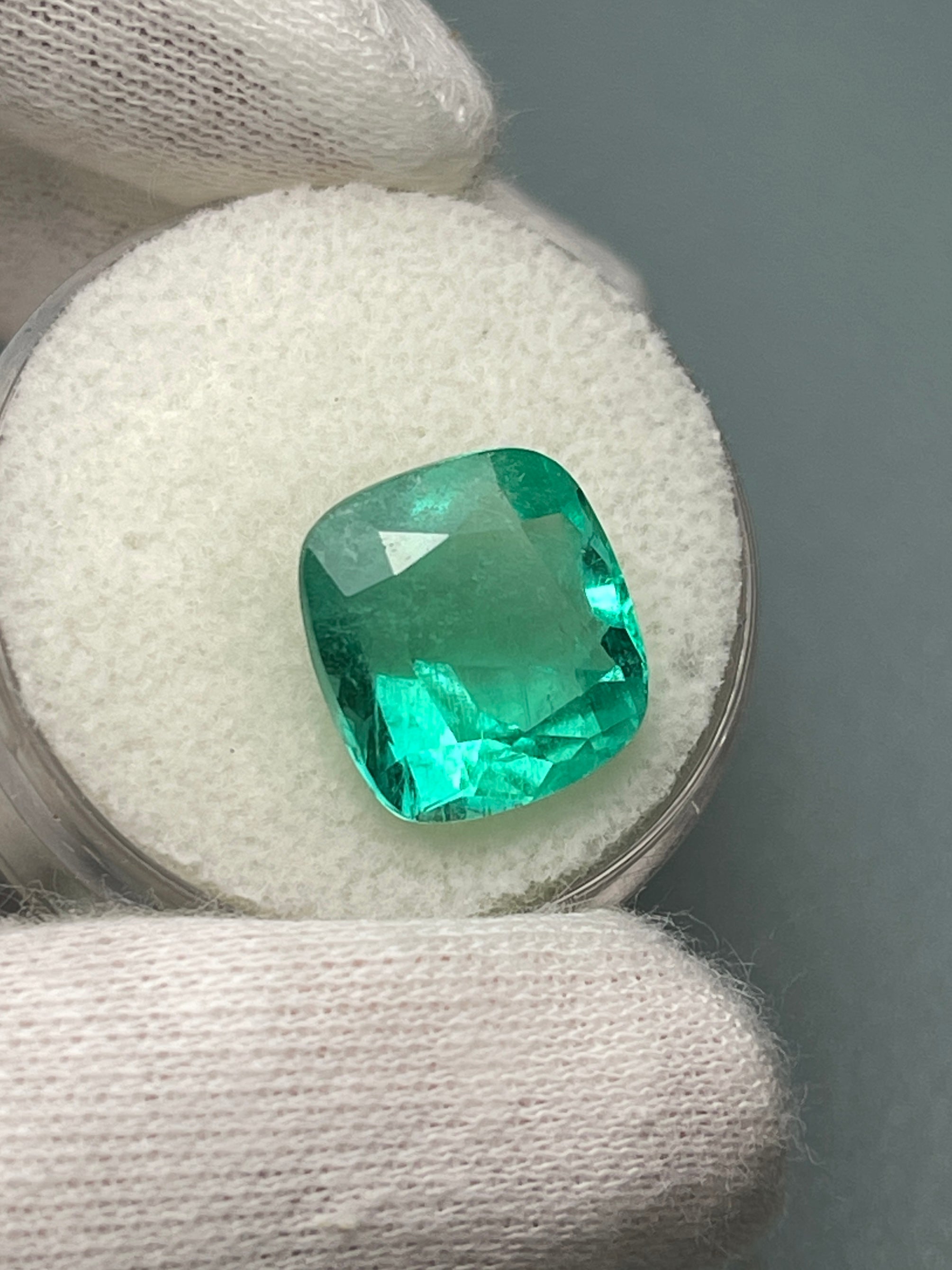 6.65 carat medium bluish green natural Colombian emerald in a cushion cut, loose gemstone from JR Colombian Emeralds.