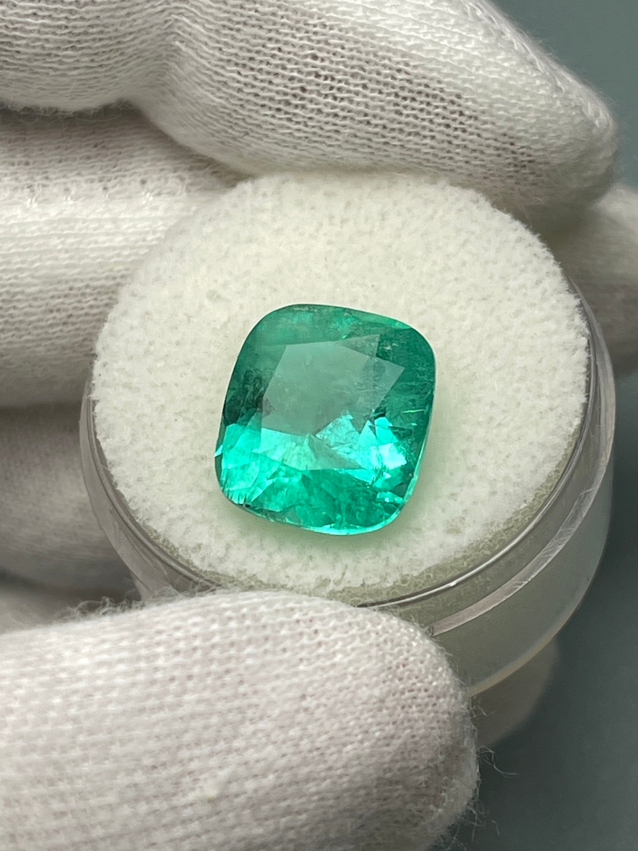 Medium bluish green 6.65 carat Colombian emerald loose cushion cut from JR Colombian Emeralds. Natural gemstone with vibrant color.