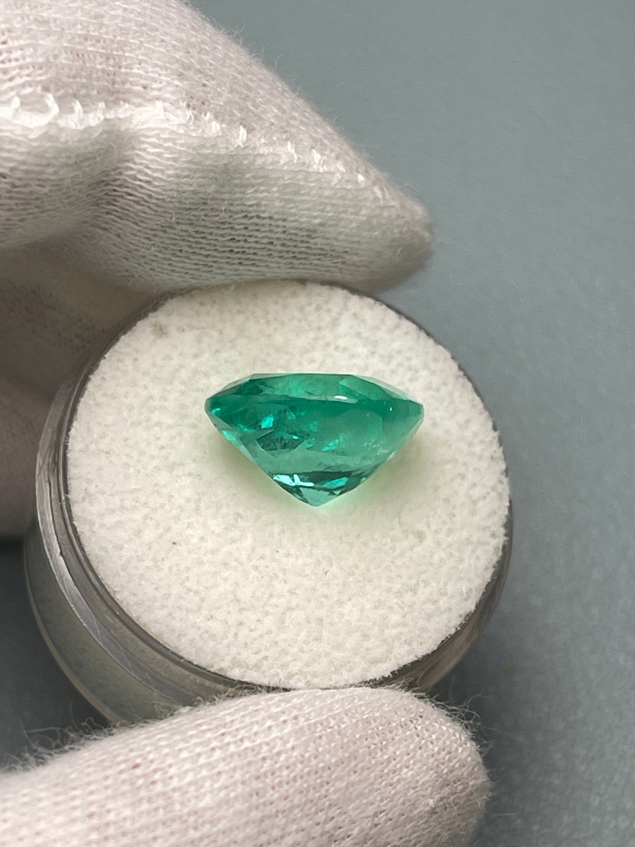6.65 carat medium bluish green Colombian emerald loose cushion cut from JR Colombian Emeralds. Natural, vibrant gemstone.
