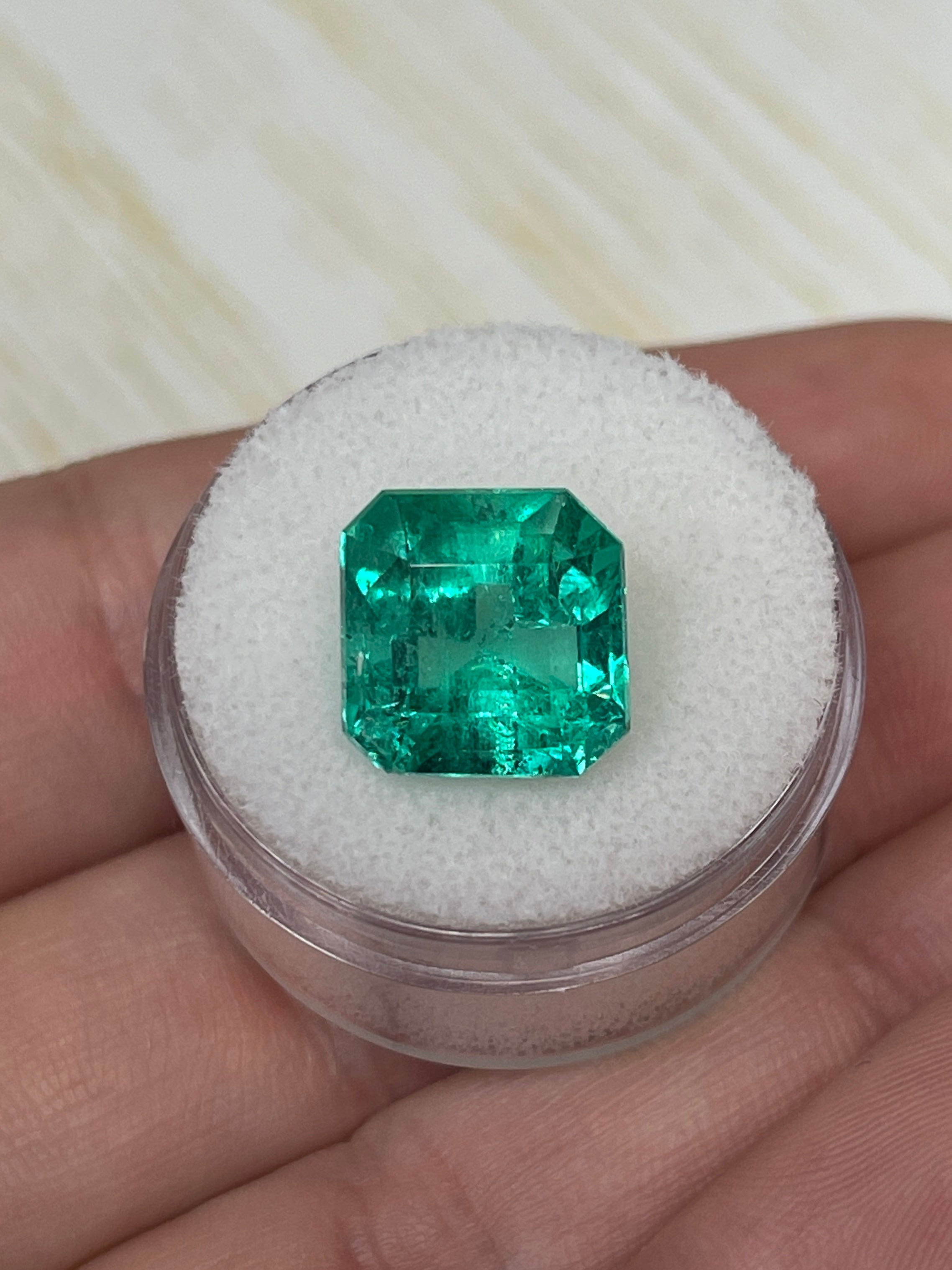 Vivid Muzo green Colombian emerald loose gemstone, 6.69 carats, 11.5x11.5 mm Asscher cut, natural and vibrant green color.