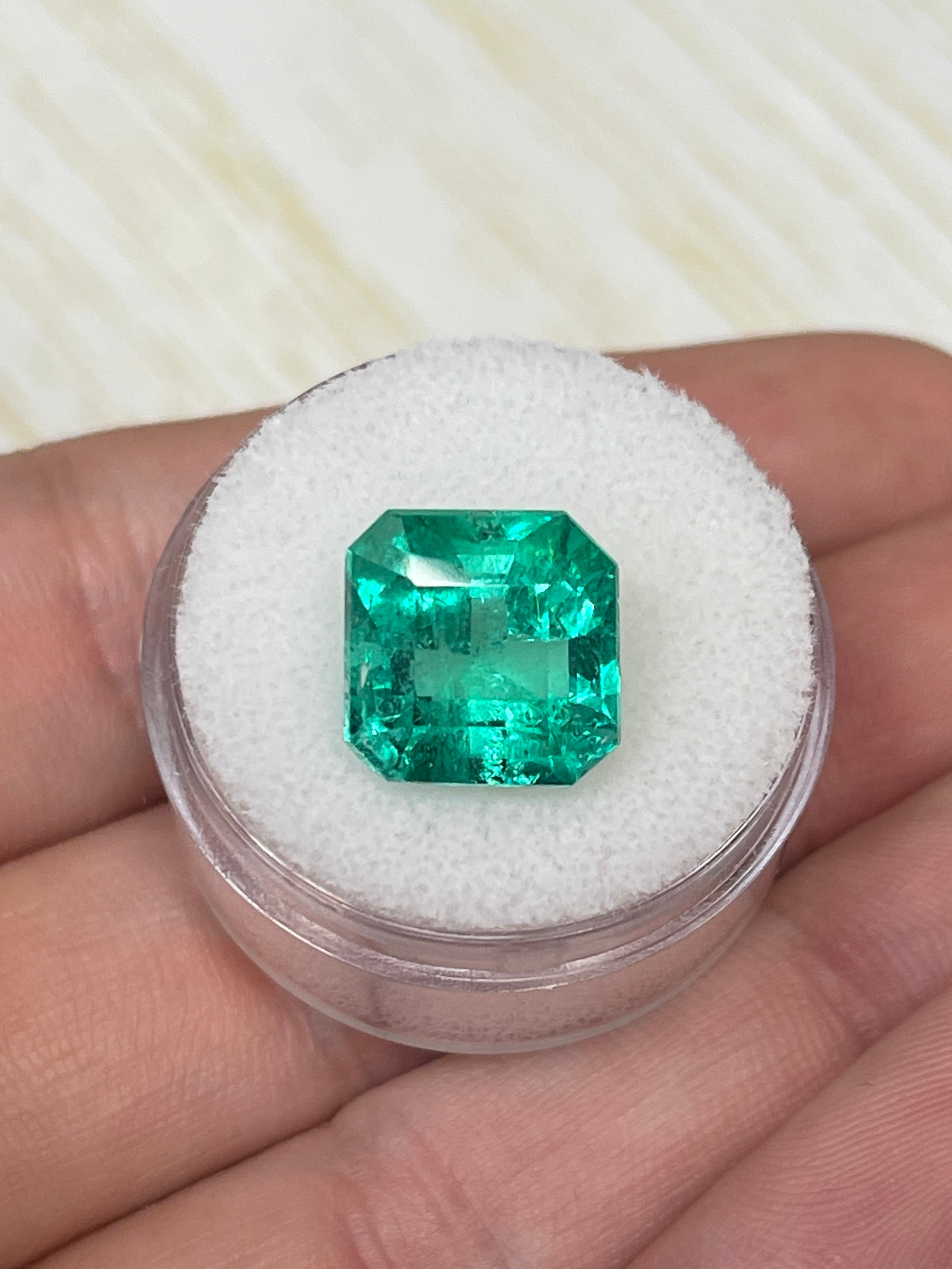 Vivid Muzo green Colombian emerald loose gemstone, 6.69 carats, Asscher cut, 11.5x11.5 mm, natural and vibrant.