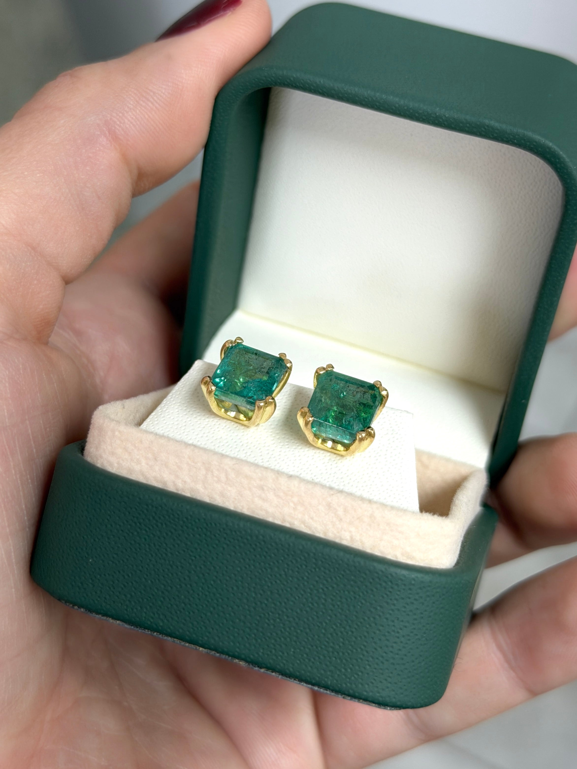 High grade 8x8mm asscher cut natural emerald double prong stud earrings by JR Colombian Emeralds, set in 18K gold.