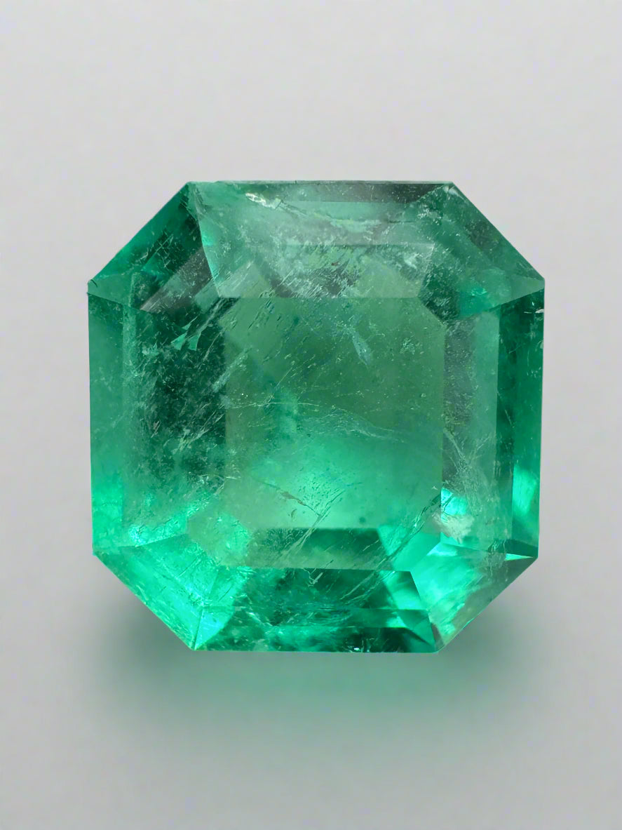 6.76 carat glowing green natural loose Colombian emerald in Asscher cut, showcasing vibrant color and clarity.