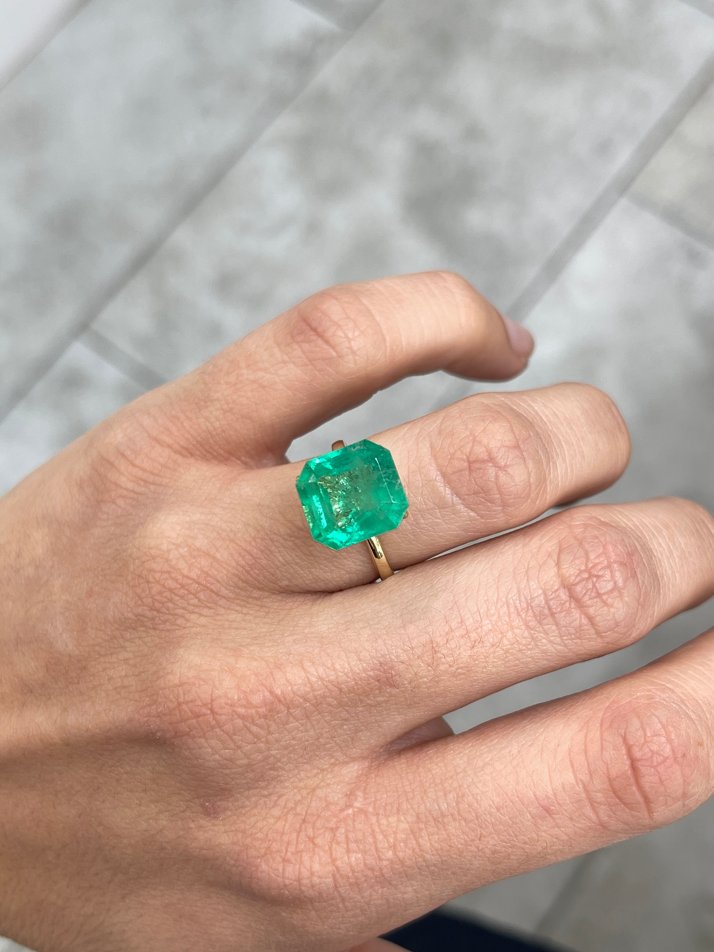 Medium green 6.93 carat natural Colombian emerald loose Asscher cut gemstone, showcasing vibrant color and clarity.