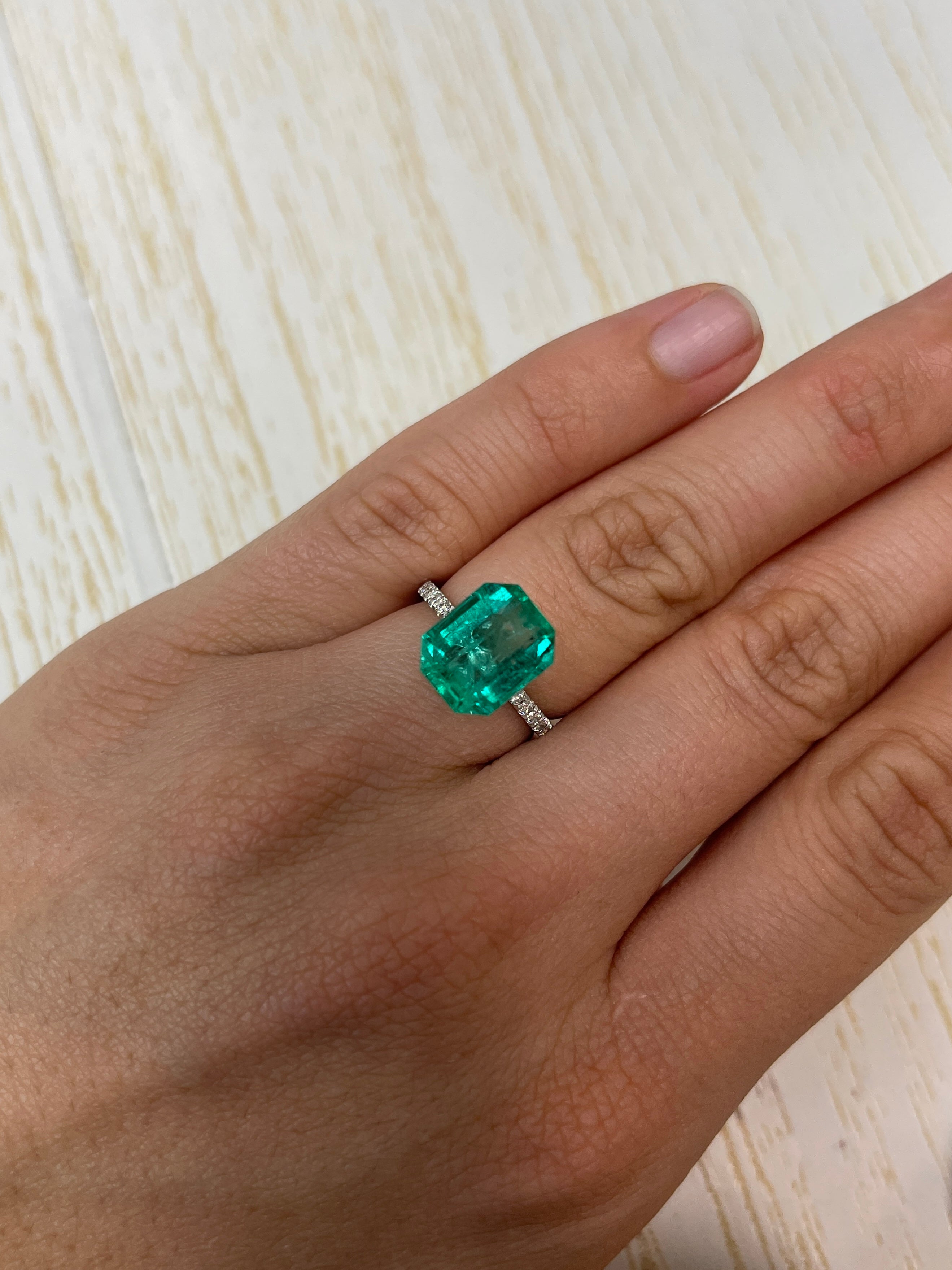 7.06 carat bluish green Colombian emerald loose gemstone in emerald cut, showcasing vibrant color and clarity, by JR Colombian Emeralds