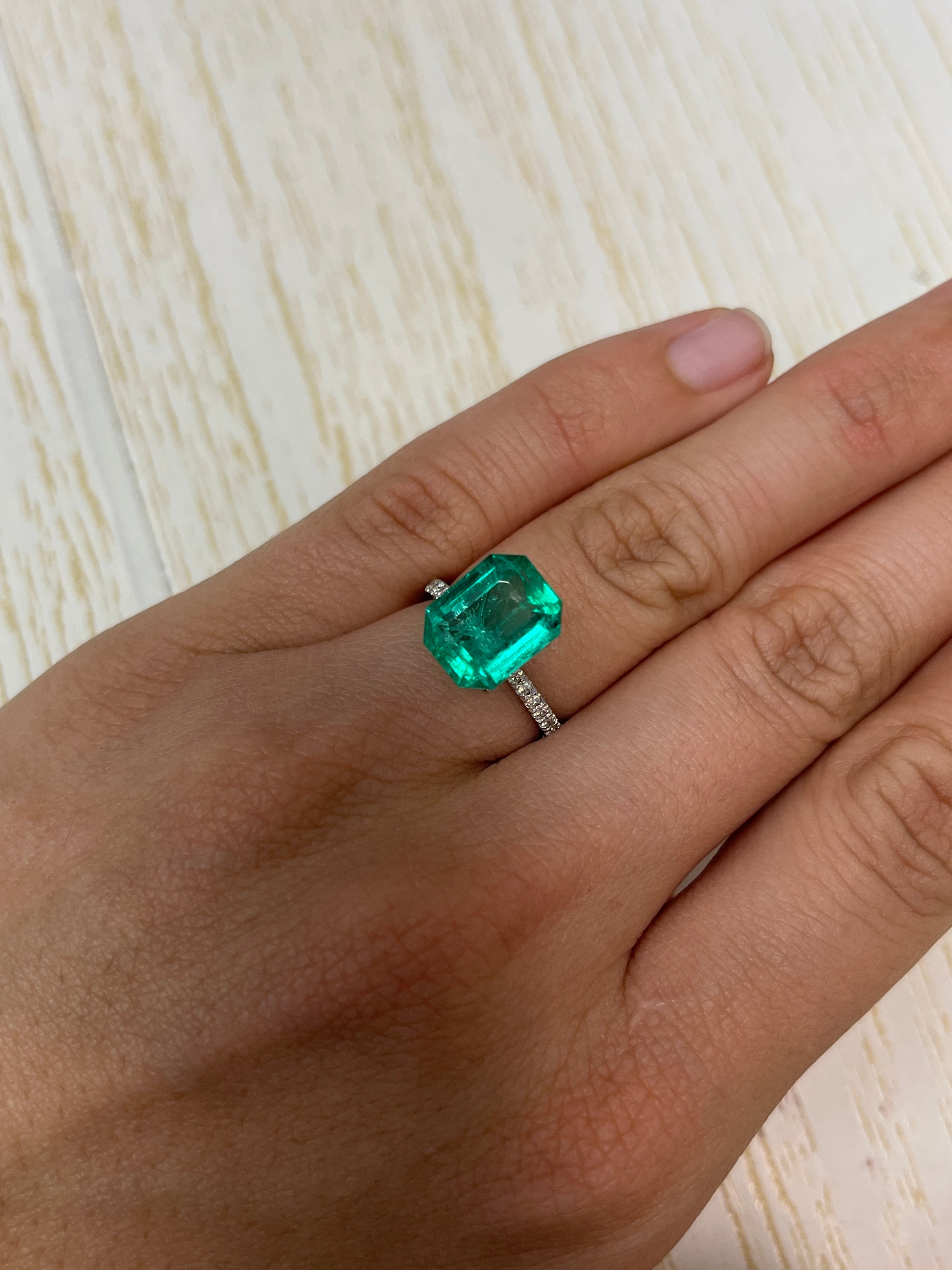 7.06 carat bluish green Colombian emerald loose gemstone in emerald cut, showcasing its vibrant color and clarity.