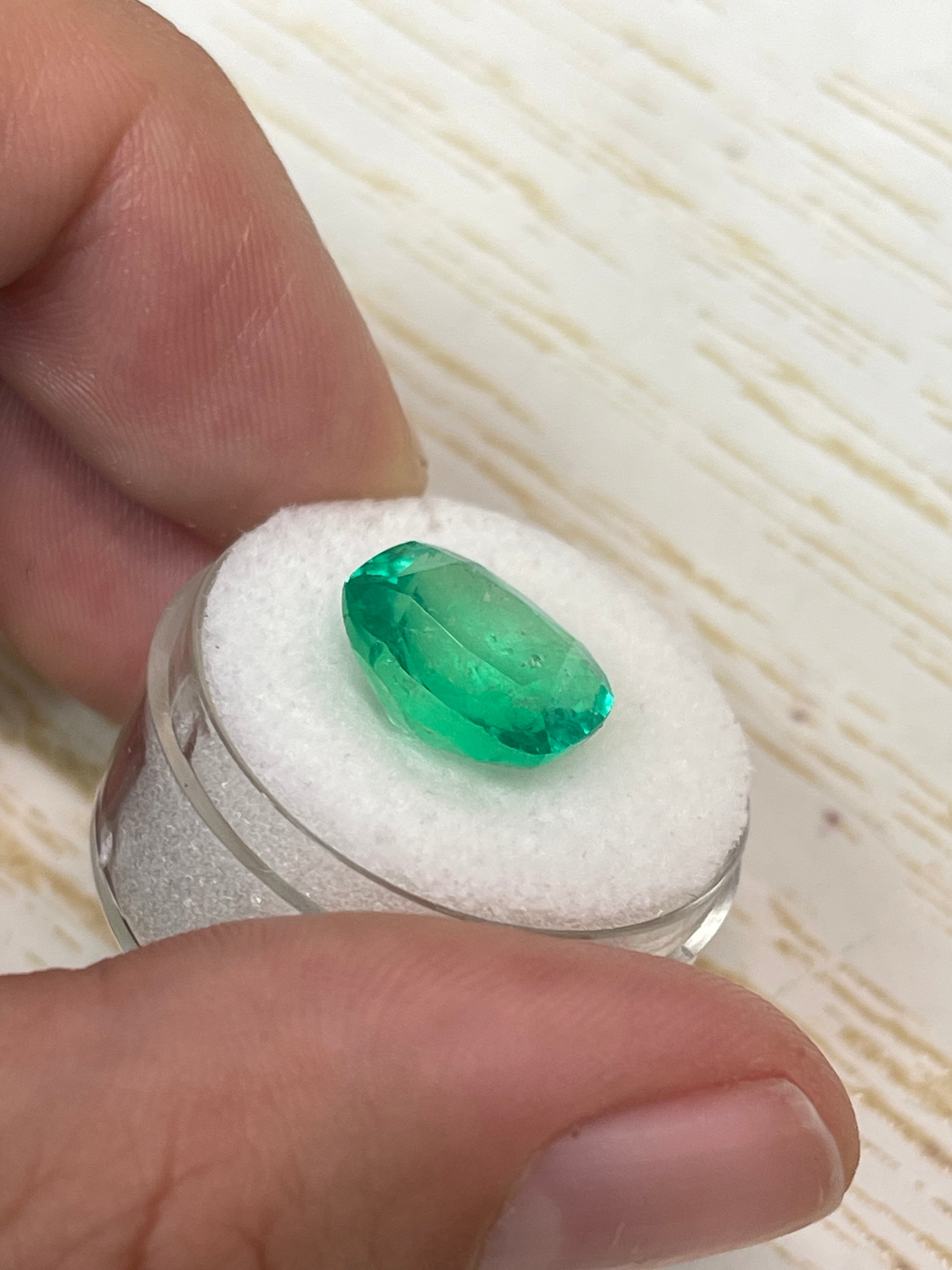 7.08 carat Muzo green Colombian emerald in cushion cut, natural loose gemstone with vibrant green color and clear clarity.
