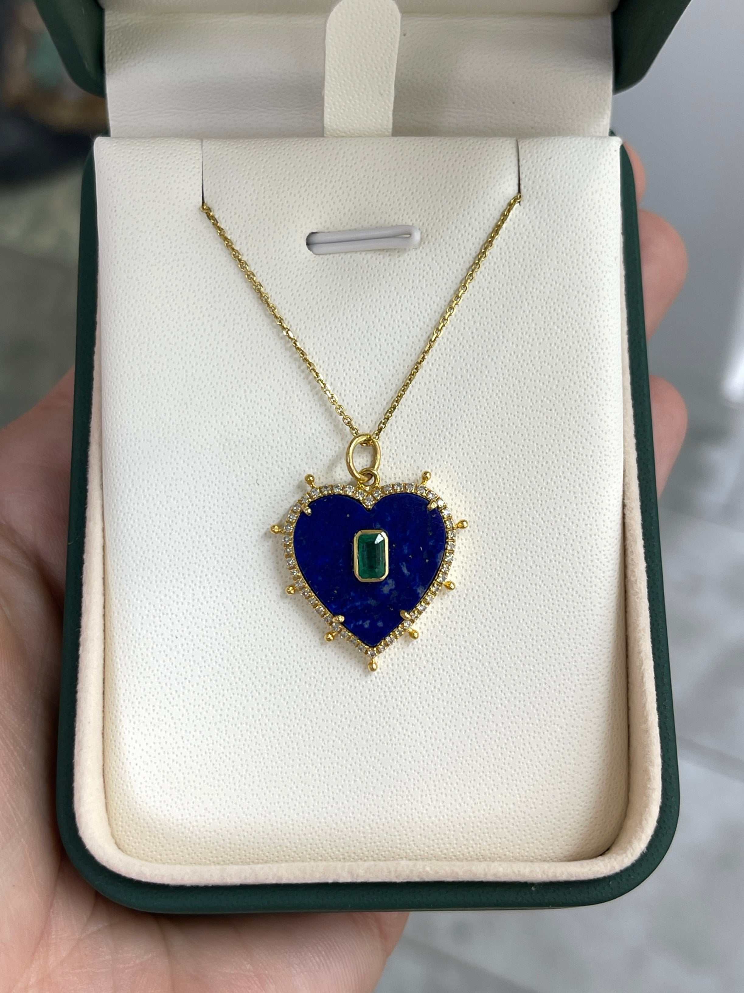 Natural lapis, emerald, and diamond heart pendant in 14K gold from JR Colombian Emeralds, showcasing vibrant gemstones and elegant design.