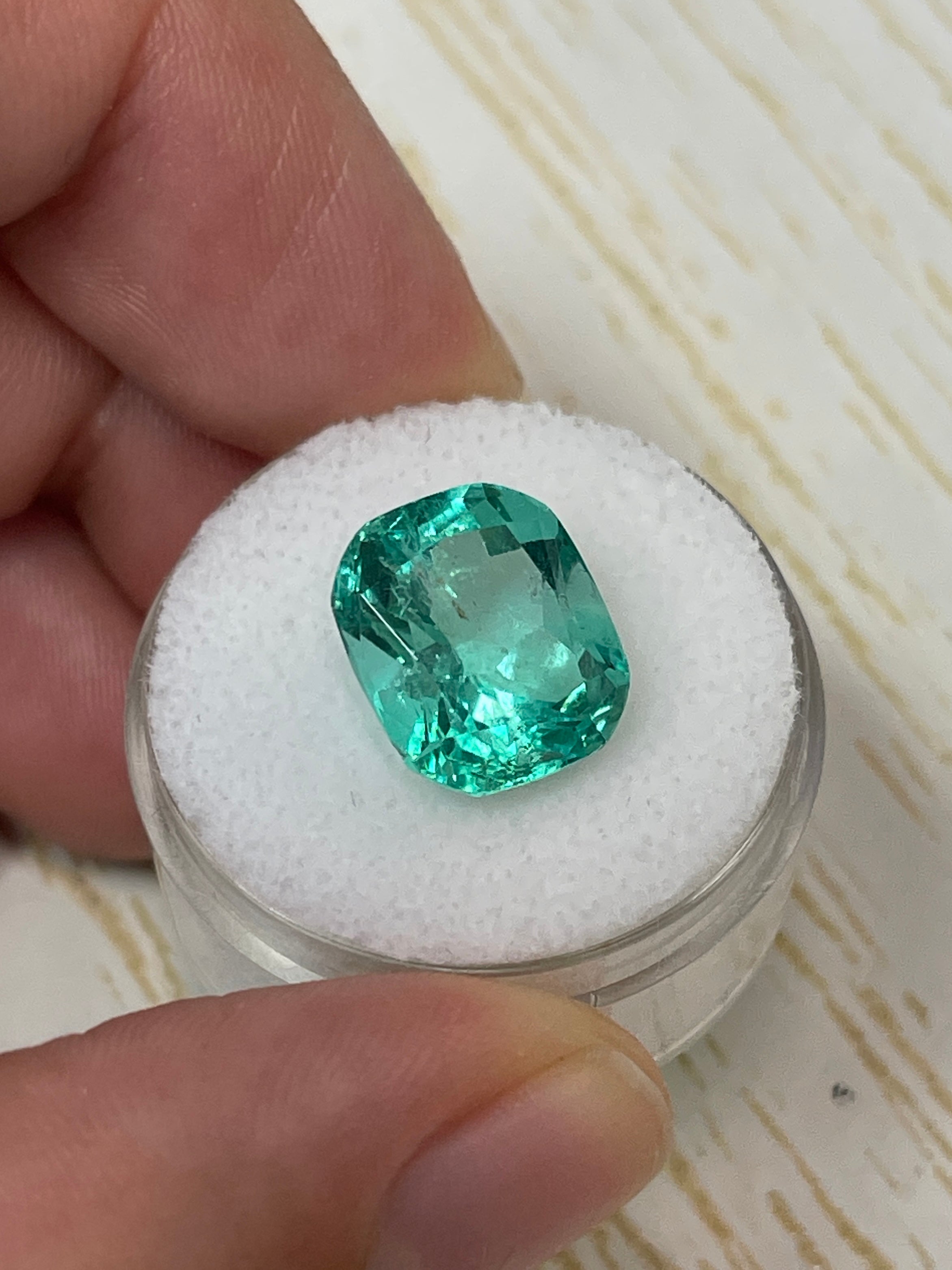 7.13 carat bluish green Colombian emerald loose cushion cut gemstone with vibrant color and natural clarity, from JR Colombian Emeralds.