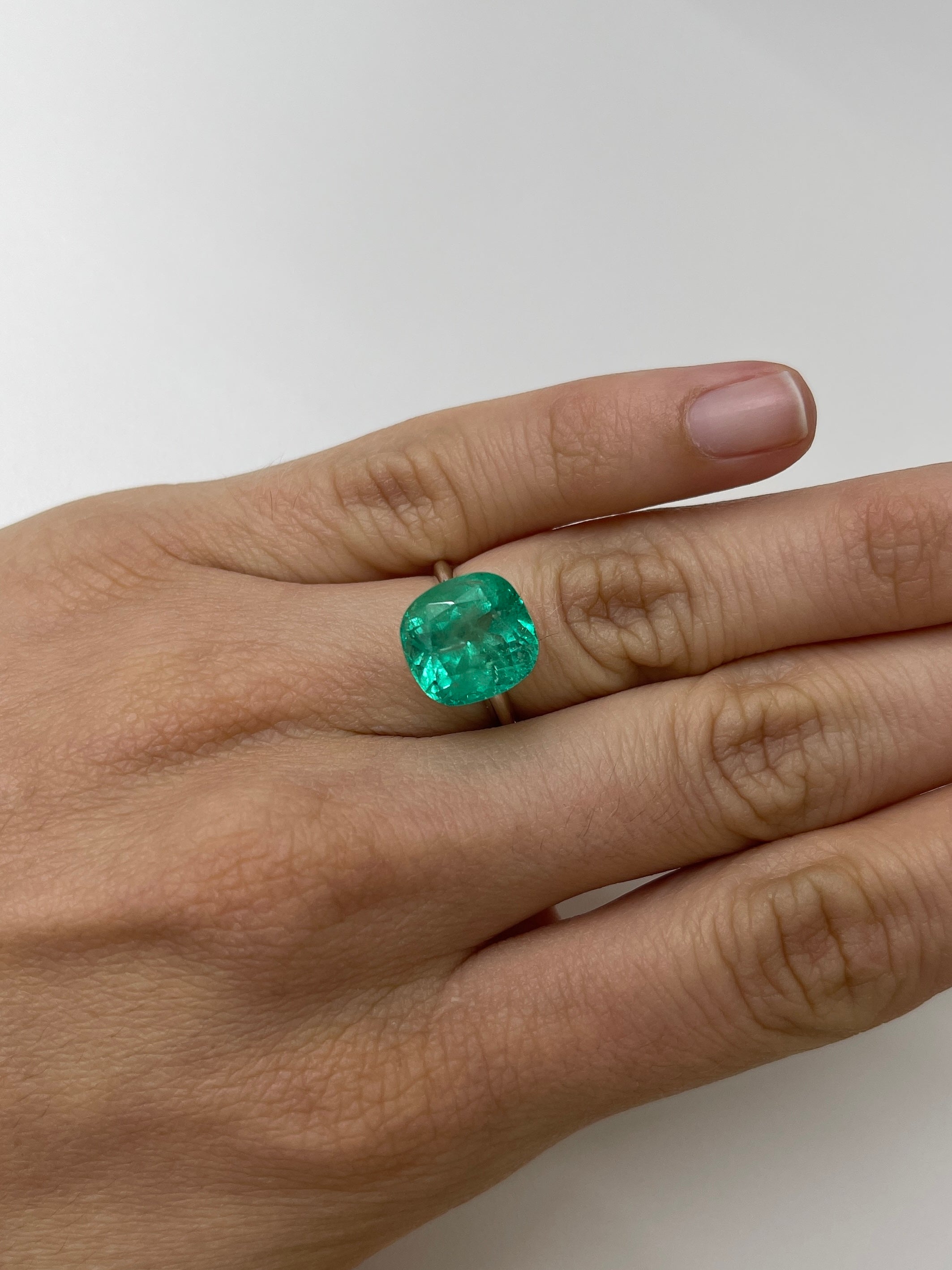7.28 carat medium bluish green Colombian emerald loose cushion cut gemstone from JR Colombian Emeralds.