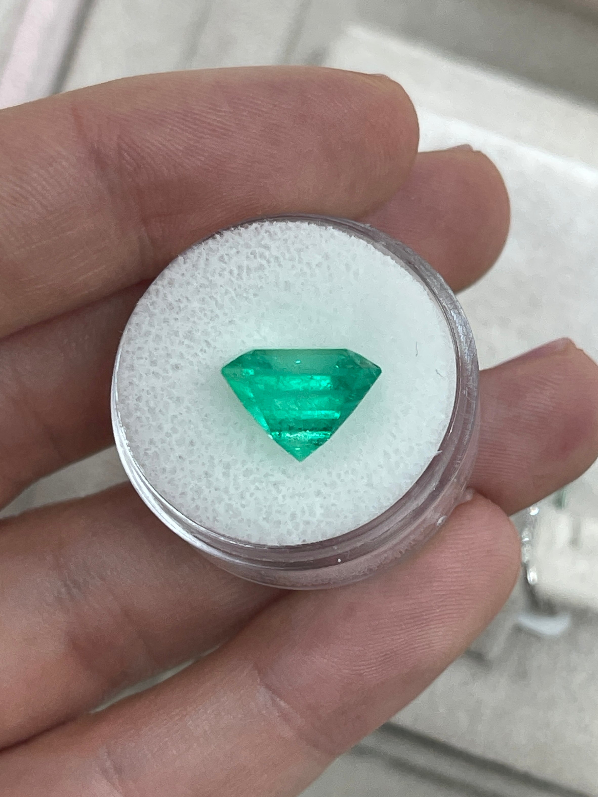 7.40 carat Muzo intense green Colombian emerald loose Asscher cut gemstone with natural, vivid green color.