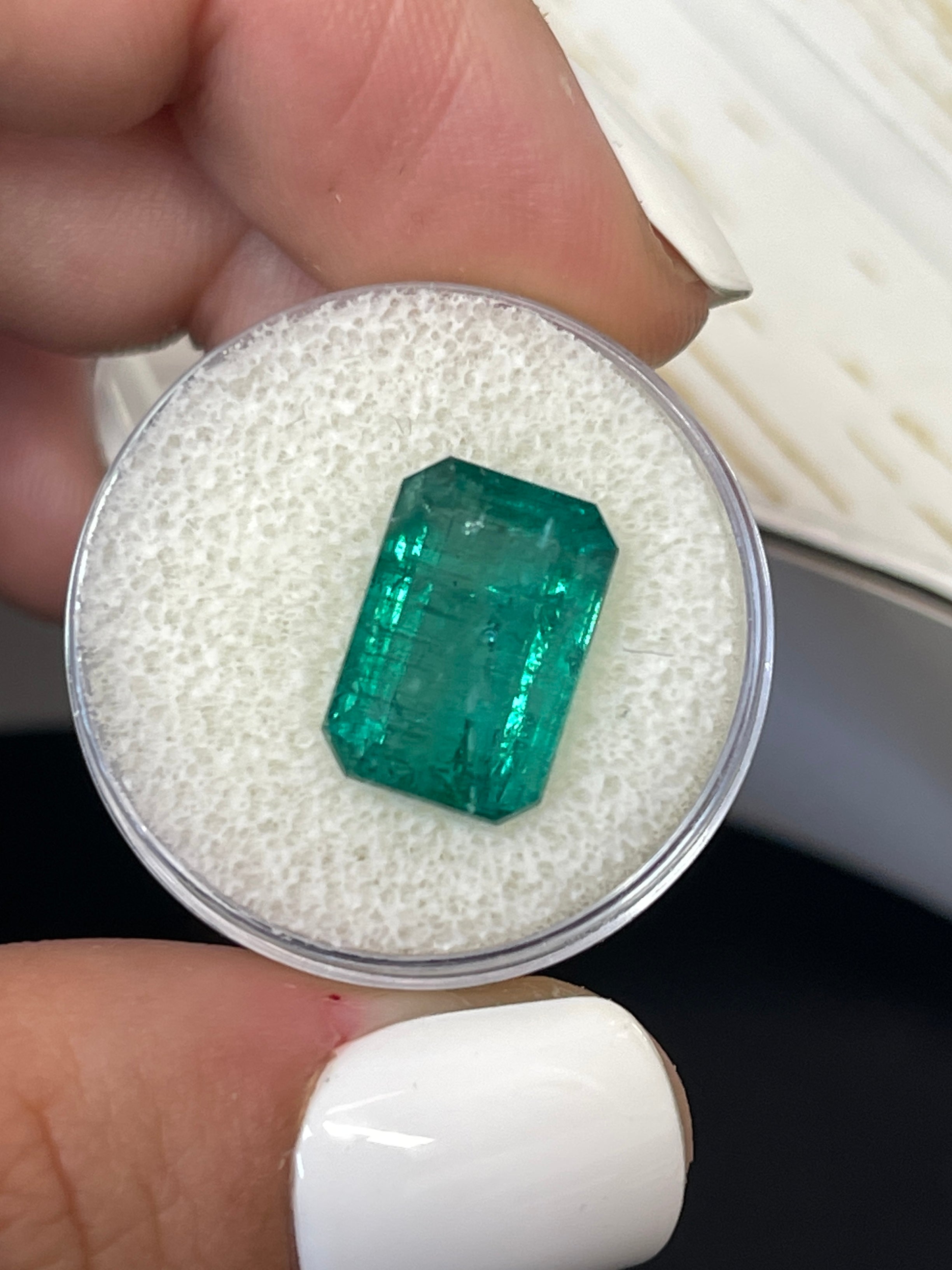 7.96-carat elongated green natural Zambian emerald cut loose gemstone, displayed with facets and clarity, from JR Colombian Emeralds.
