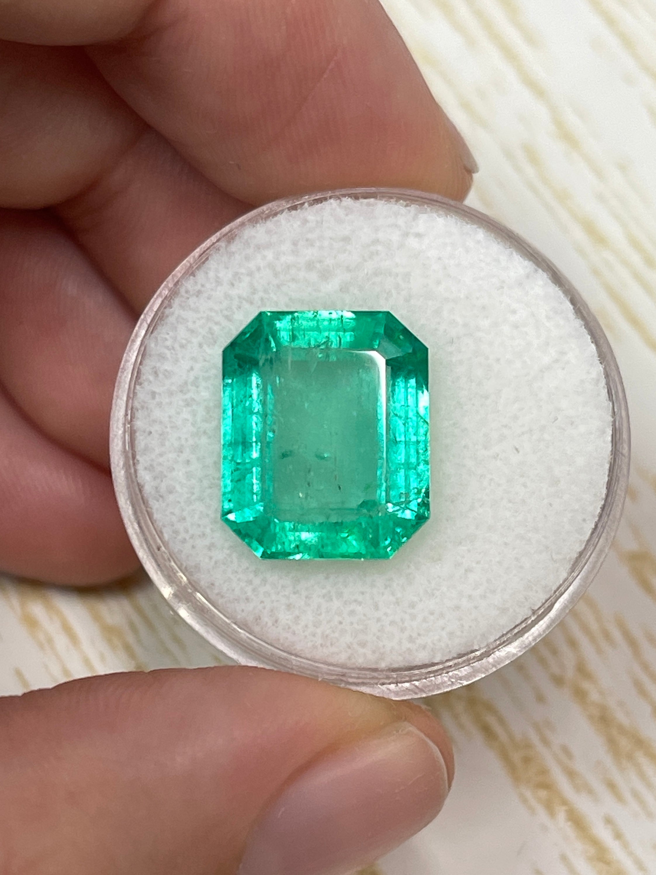 8.20 carat medium green Colombian emerald cut loose emerald gemstone from JR Colombian Emeralds, showcasing its vibrant color and clarity.