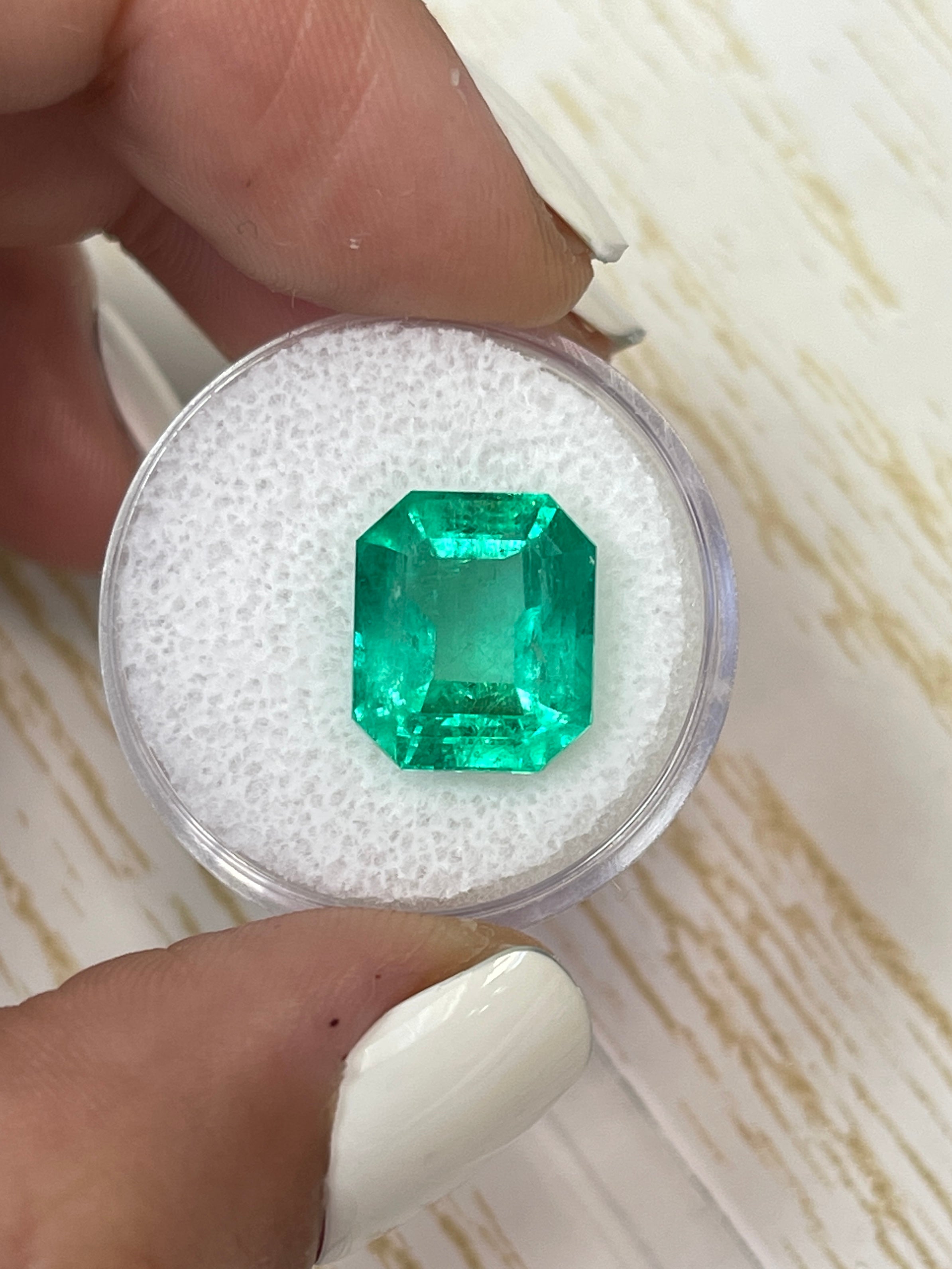 8.51 carat Colombian emerald cut loose emerald from JR Colombian Emeralds, featuring a classic 13x11 mm shape and vibrant green color.