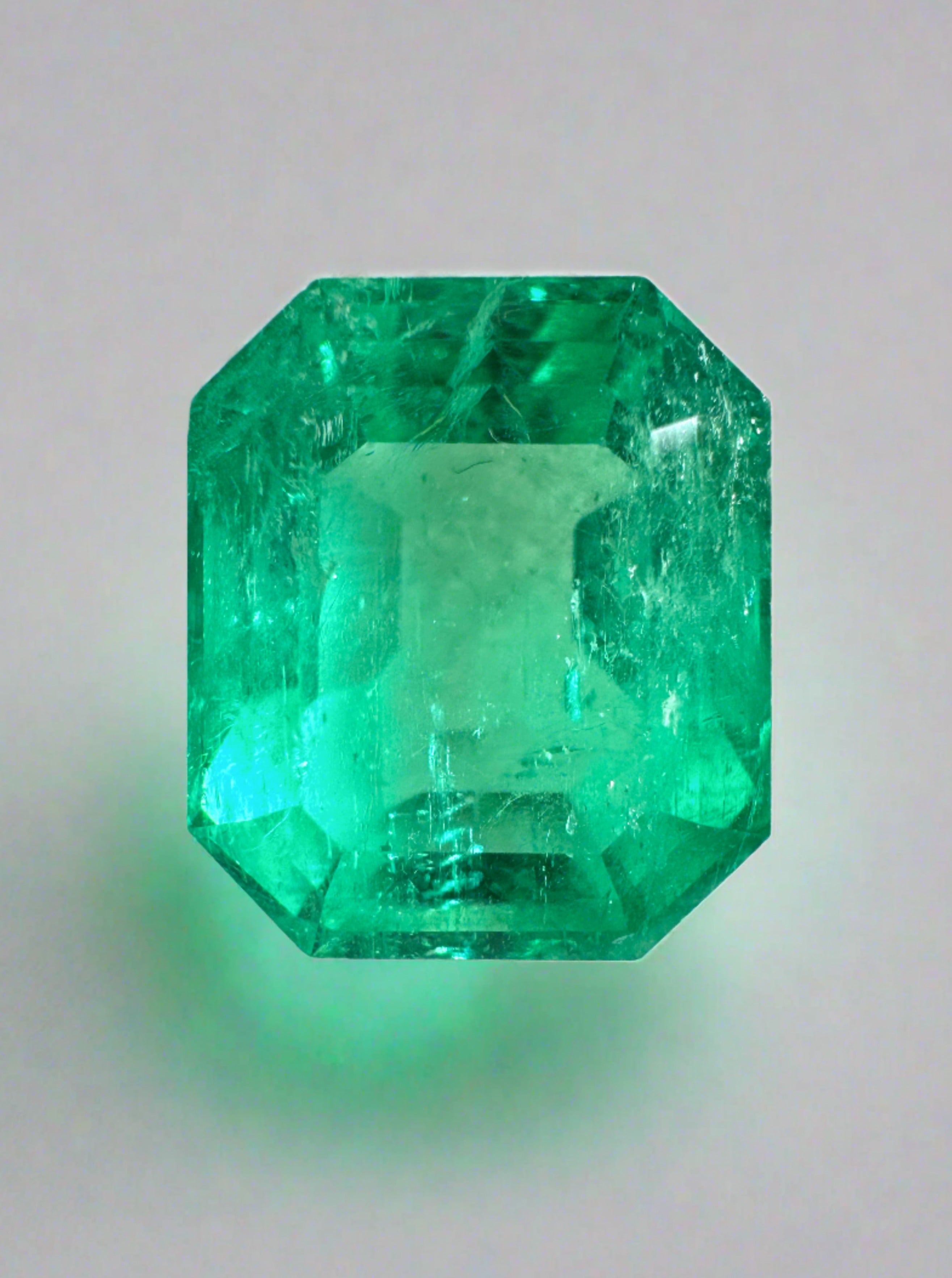 8.51 carat Colombian emerald cut loose gemstone with classic 13x11 emerald shape, showcasing vibrant green color and clarity.