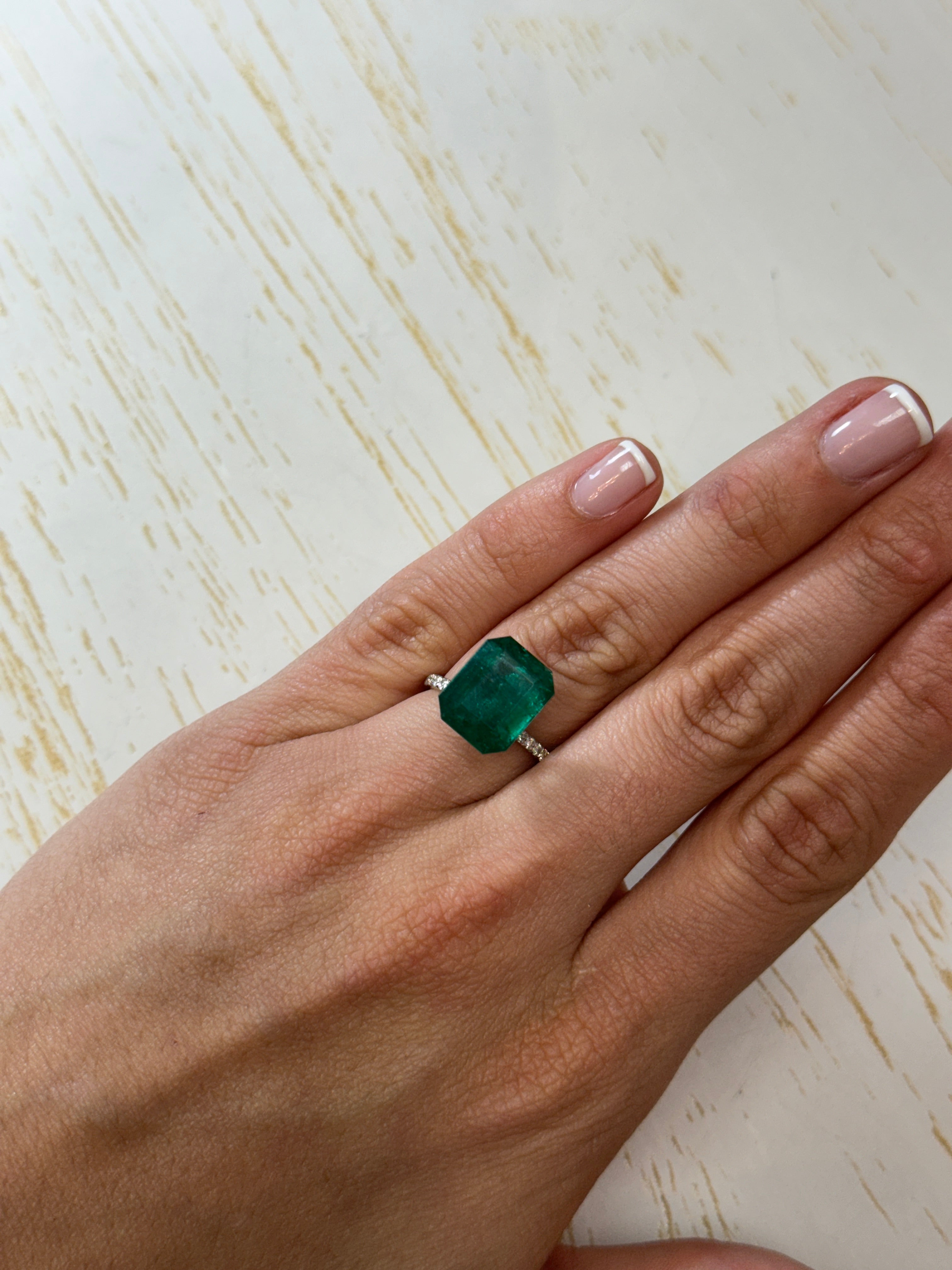 Deep green 8.60 carat Zambian emerald cut loose gemstone by JR Colombian Emeralds showing vibrant color and clarity.