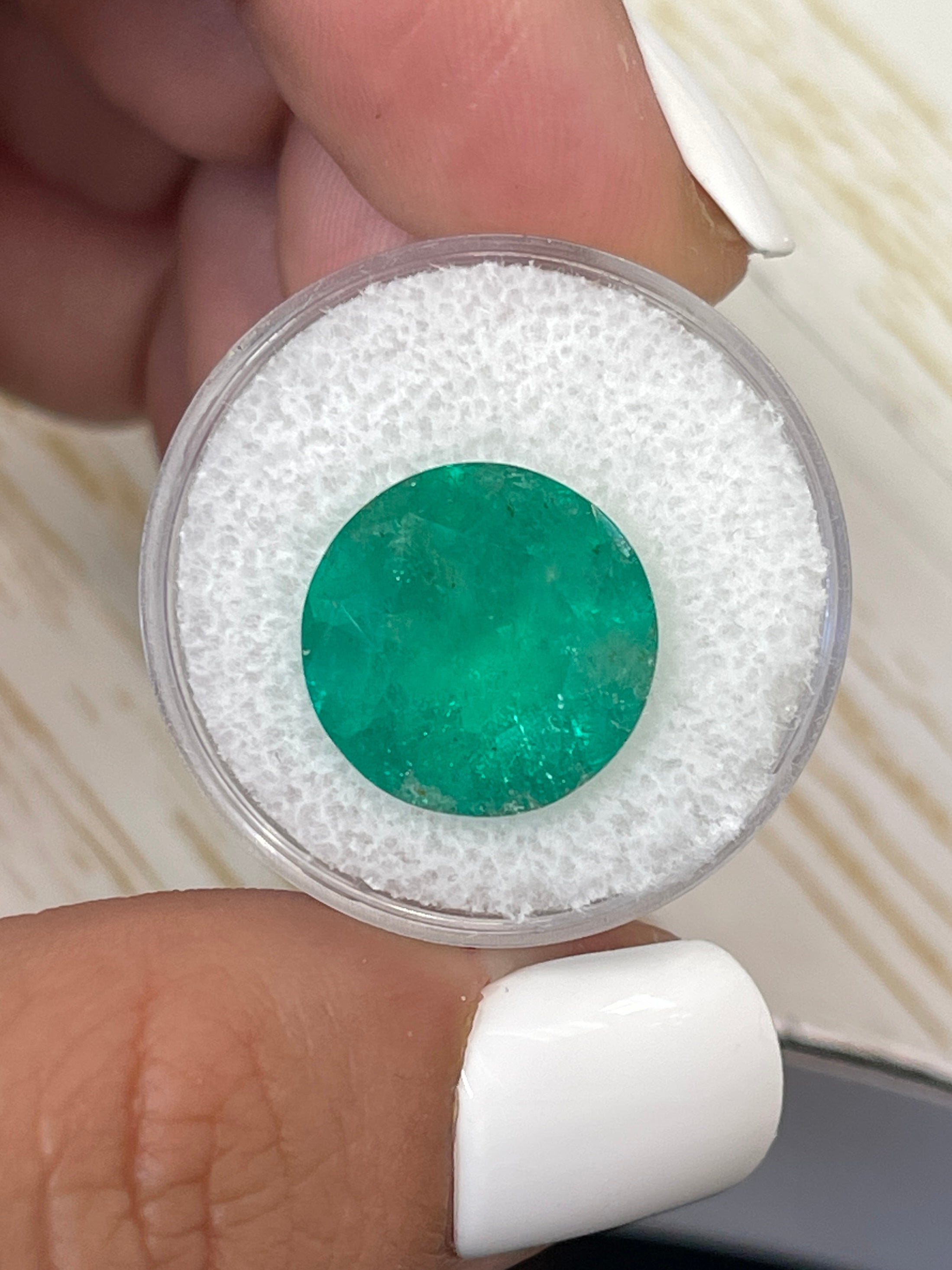 Deep green 8.80 carat round Colombian emerald loose gemstone with natural clarity, 14.5x14.5mm size, from JR Colombian Emeralds.
