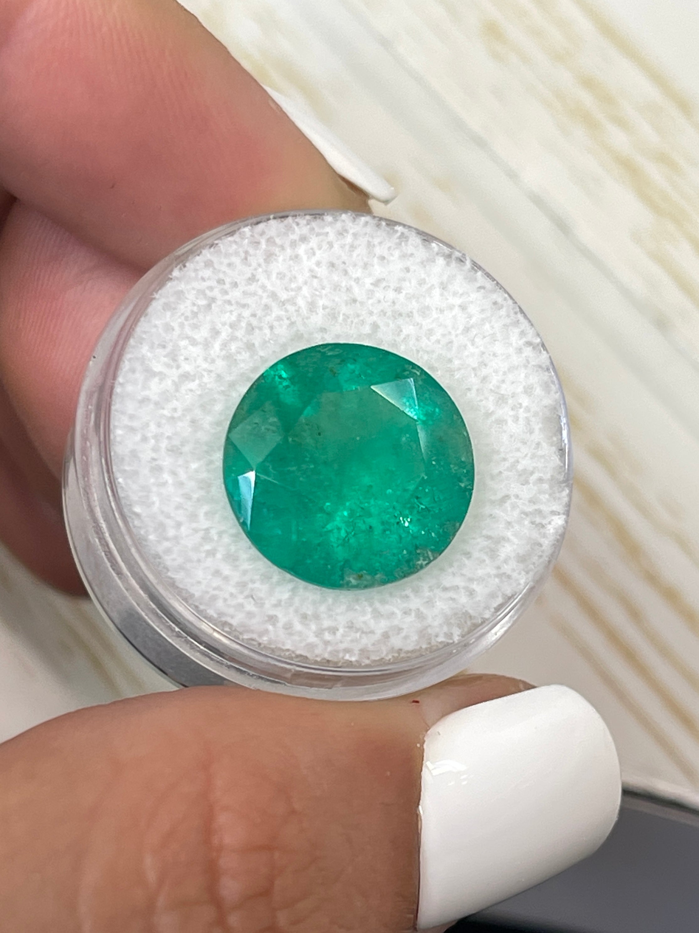 Deep green 8.80 carat natural round Colombian emerald gemstone with a 14.5x14.5mm cut, loose gemstone from JR Colombian Emeralds.
