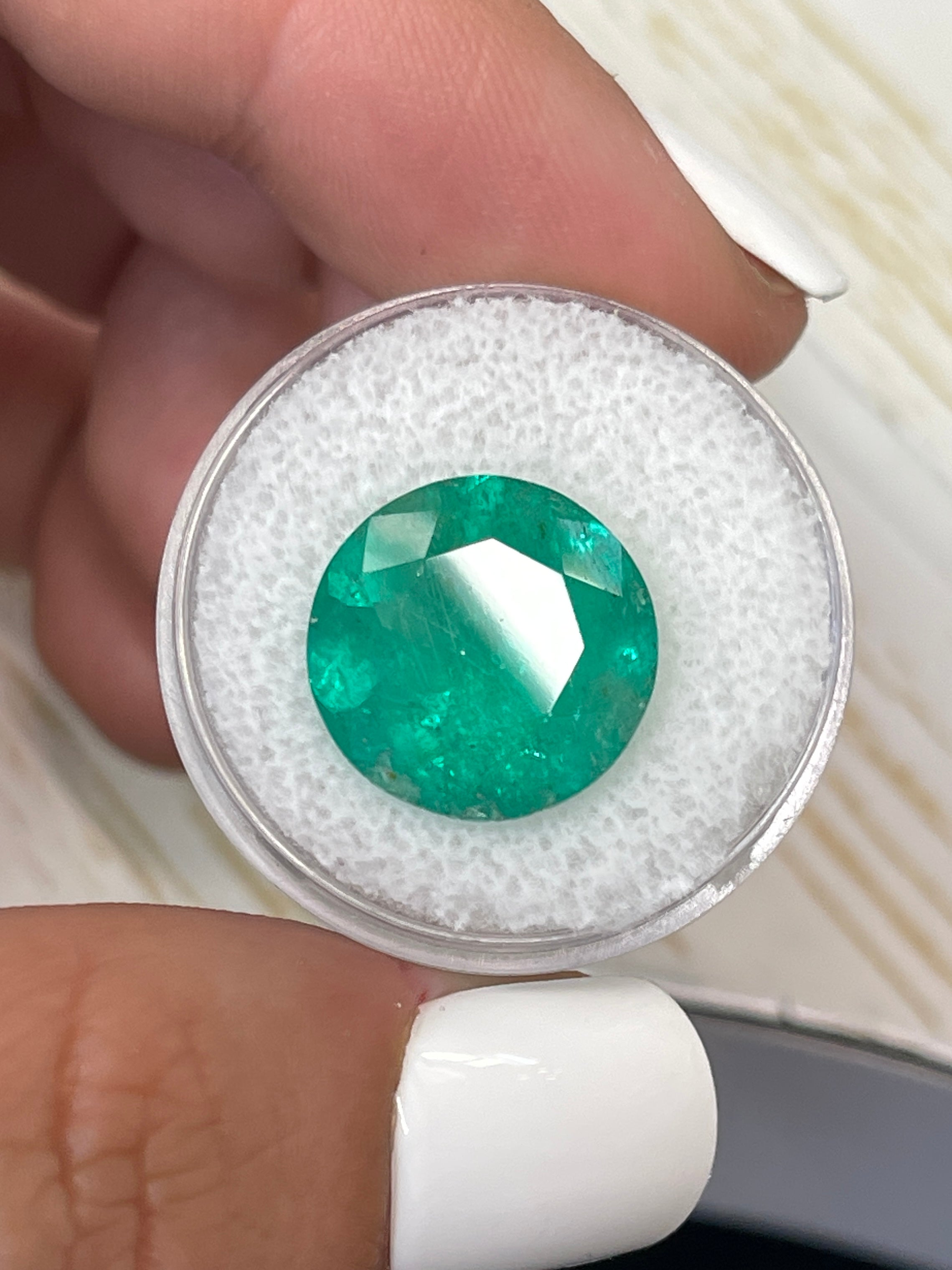Deep green 8.80 carat round Colombian emerald loose gemstone by JR Colombian Emeralds, natural and vibrant in appearance.