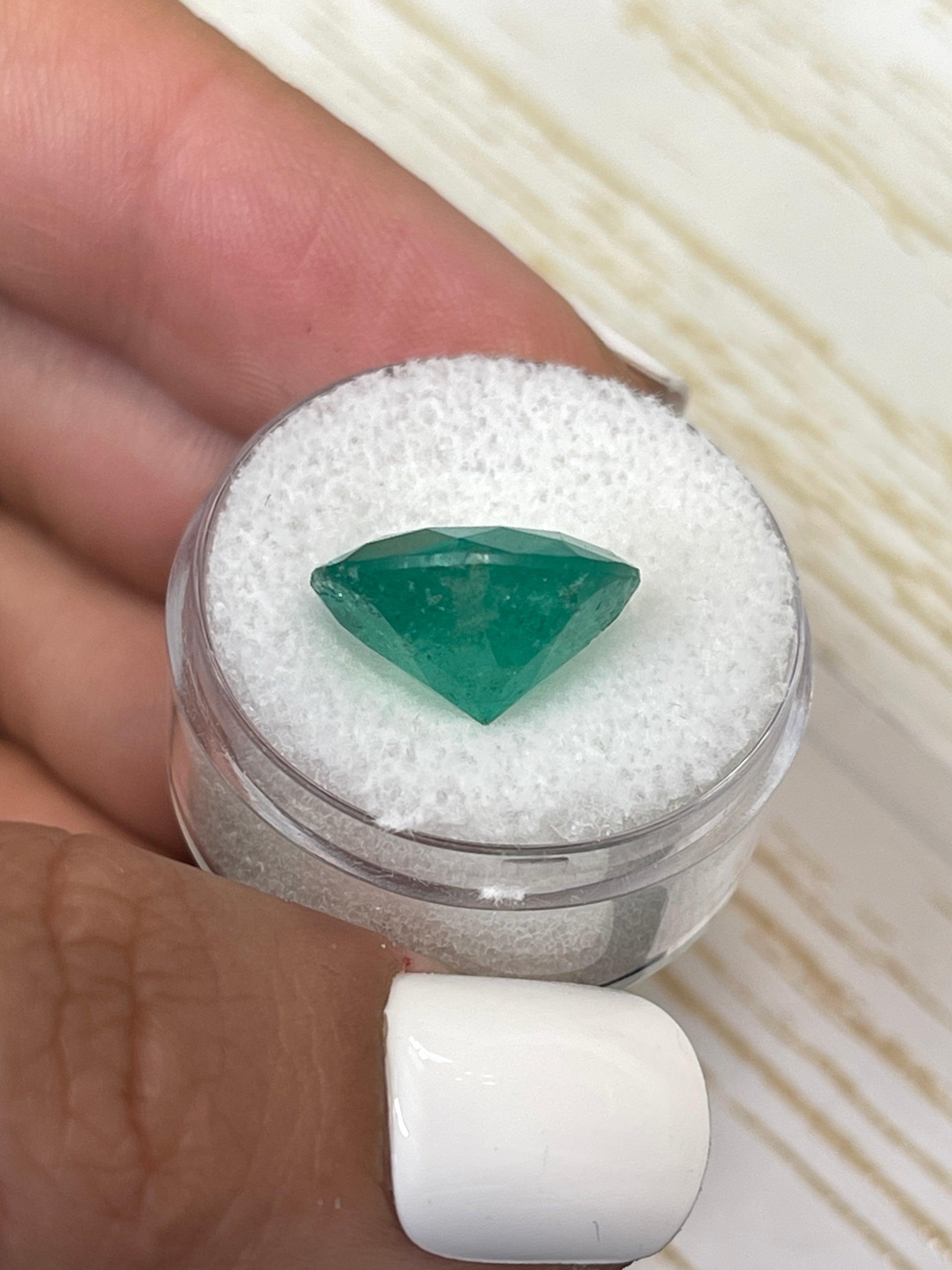 Deep green 8.80 carat round Colombian emerald loose gemstone with natural clarity and vibrant color.
