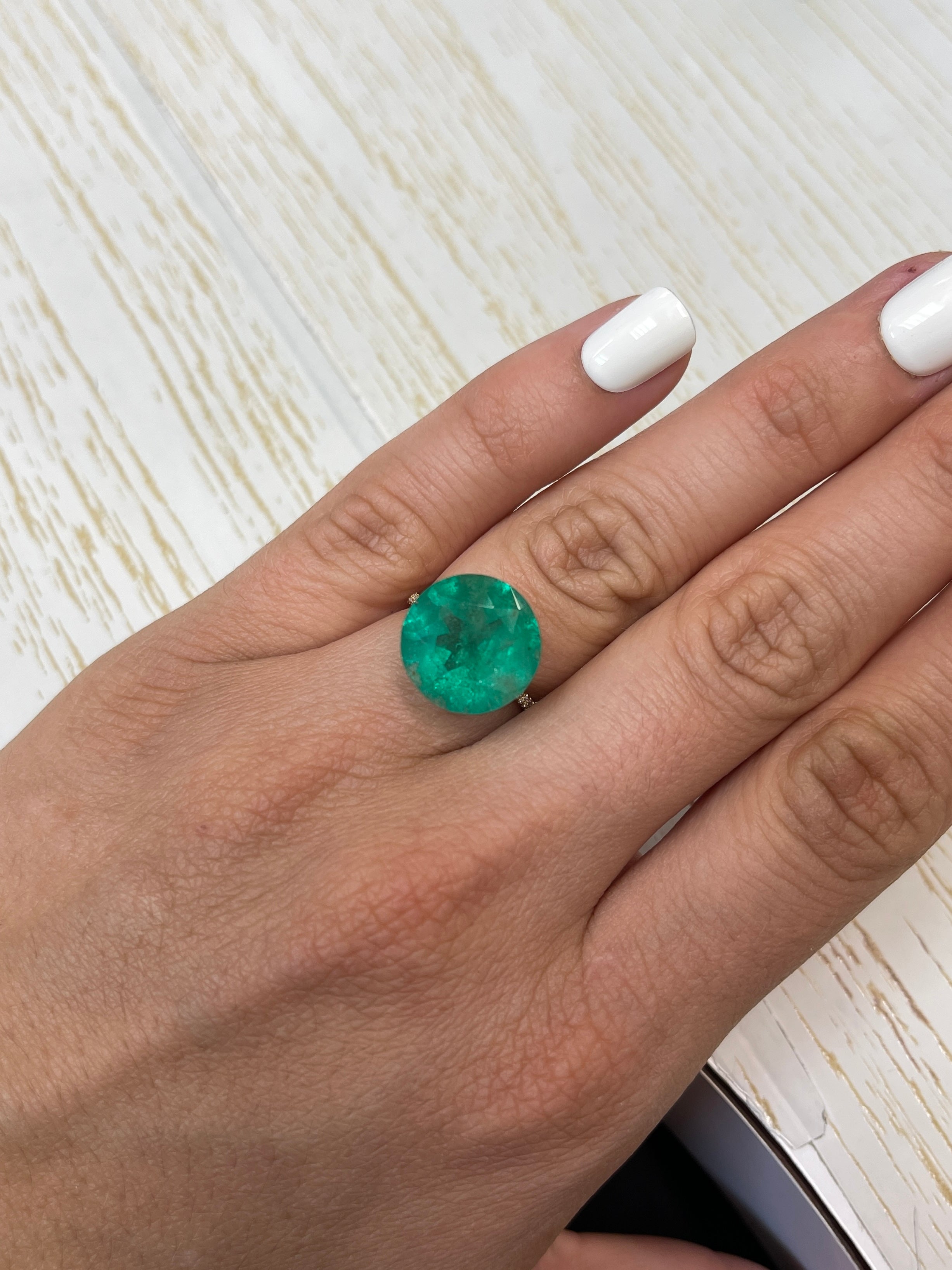 Deep green 8.80 carat natural round Colombian emerald gemstone with 14.5x14.5mm size, loose and uncut.