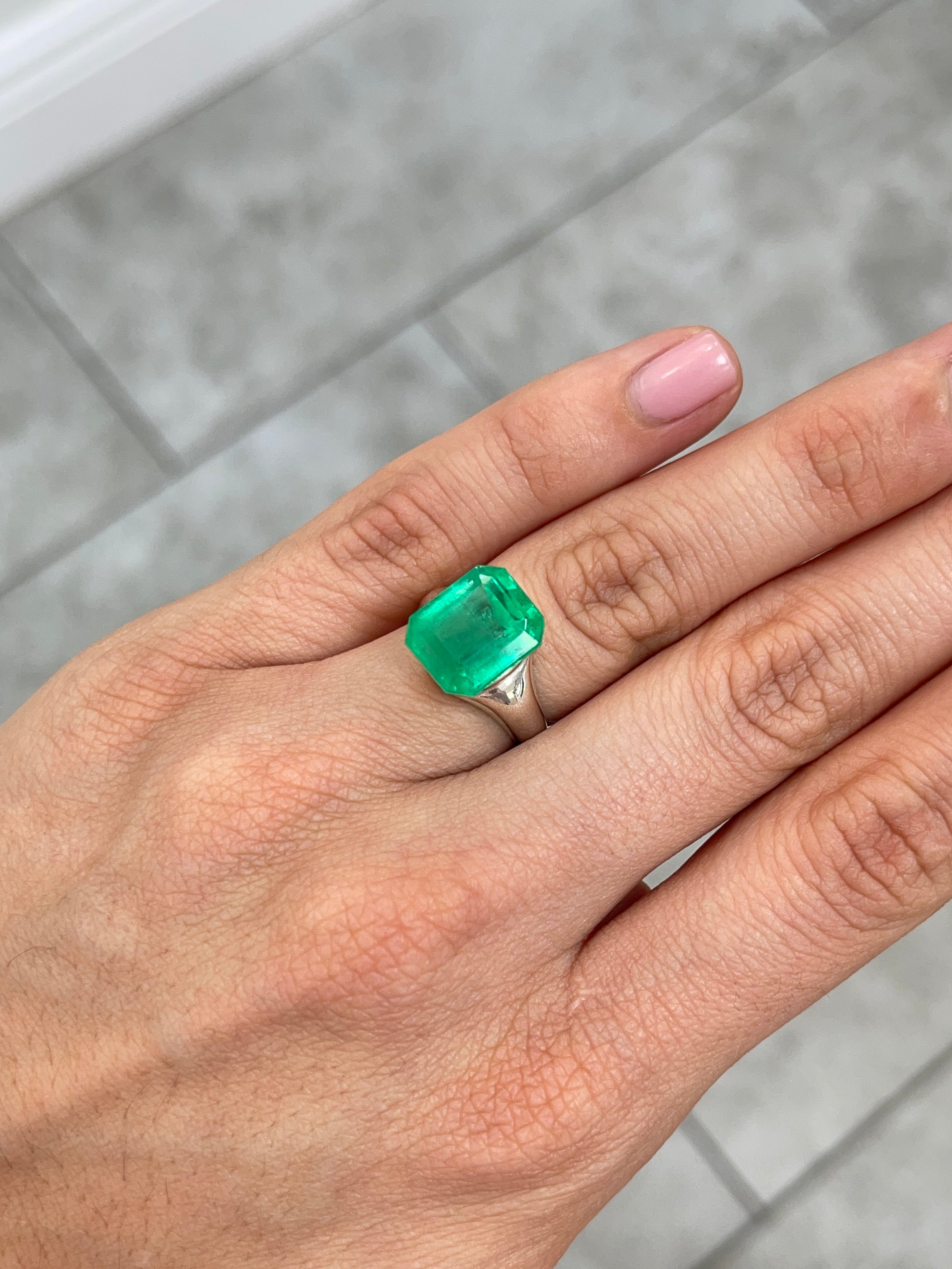 Vivid 8.98 carat Colombian emerald loose gemstone with 13x11 emerald cut, showcasing vibrant green color and clarity.
