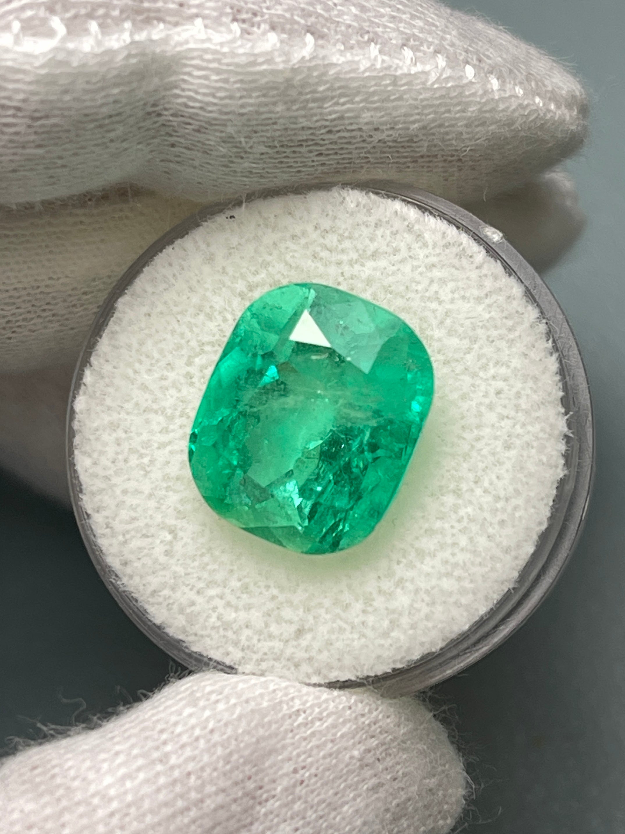 Natural loose Colombian emerald, 9.23 carats, cushion cut, yellowish green Muzo gemstone from JR Colombian Emeralds.