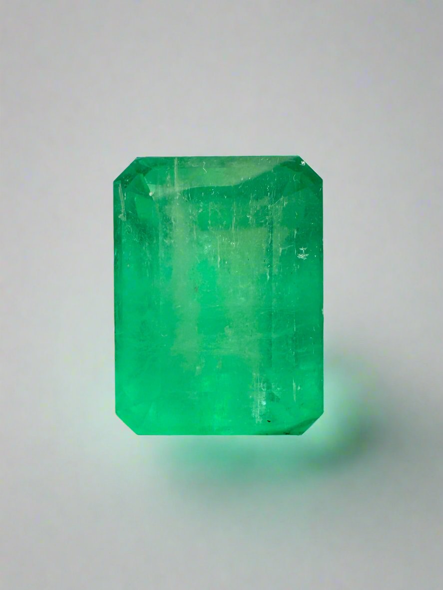 Medium green 9.29 carat Colombian emerald cut loose gemstone with earthy tone, showcasing the vibrant emerald cut and clarity.