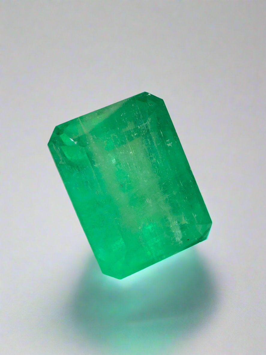 Loose 9.29 carat Colombian emerald cut emerald with medium green earthy tone, featuring a 13x10mm gemstone from JR Colombian Emeralds.