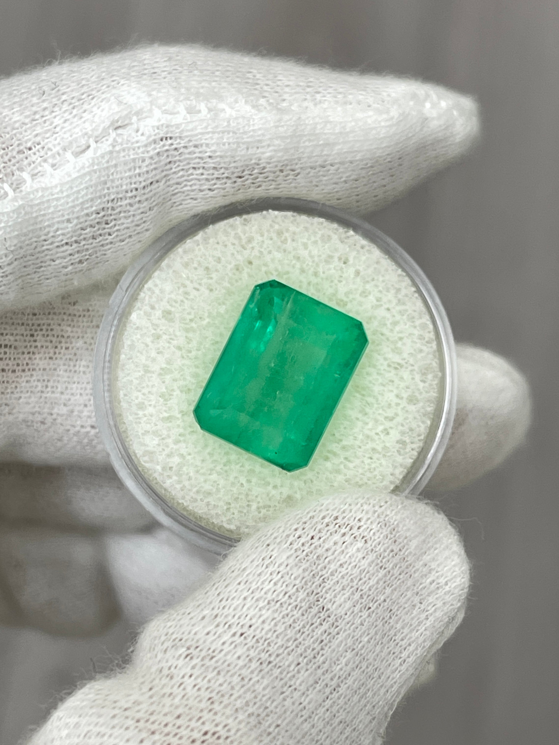 Medium green 9.29 carat Colombian emerald cut loose gemstone from JR Colombian Emeralds, showcasing earthy color and clarity.