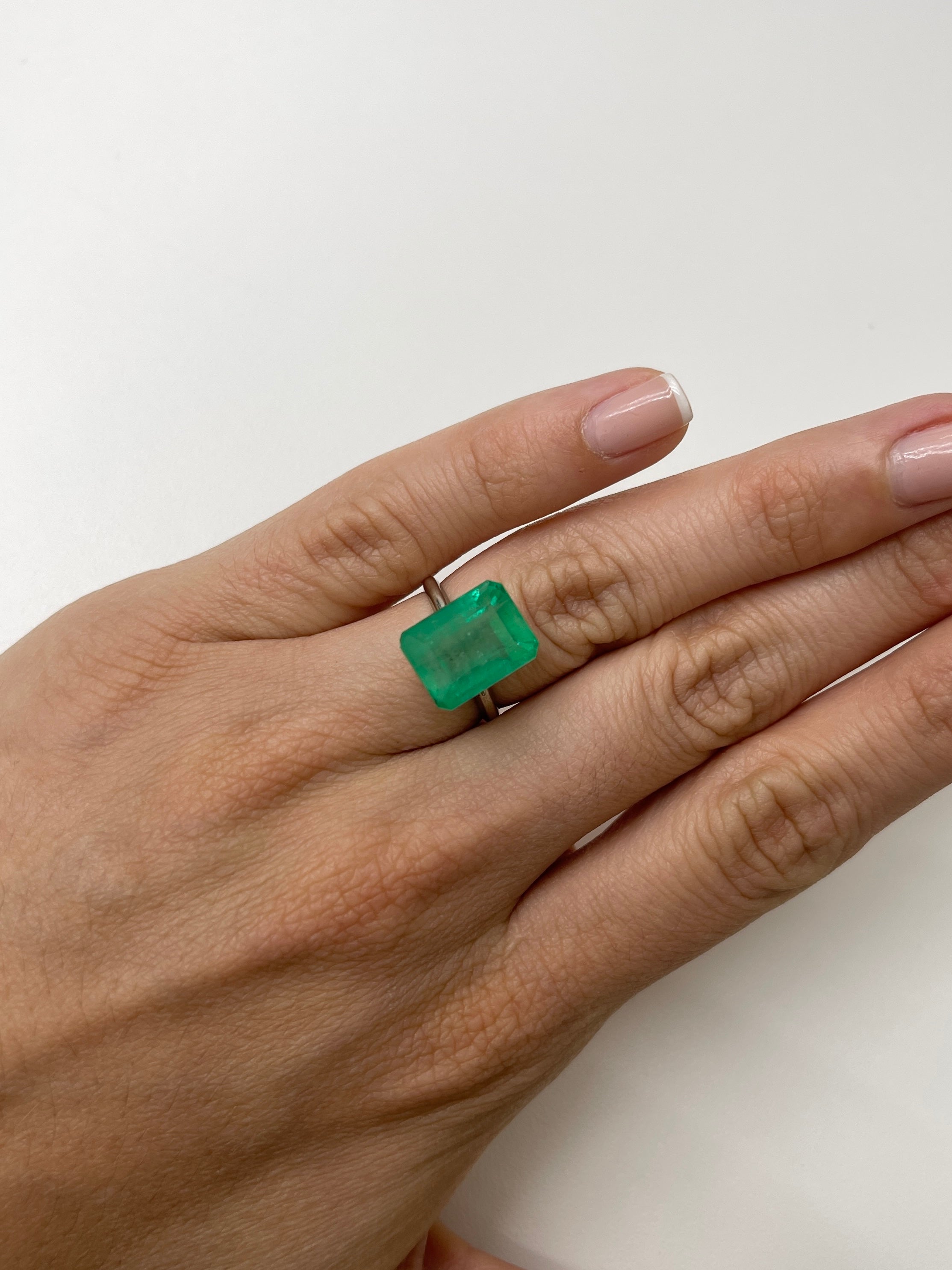 9.29 carat medium green Colombian emerald cut loose gemstone from JR Colombian Emeralds, showcasing earthy green color and clarity.