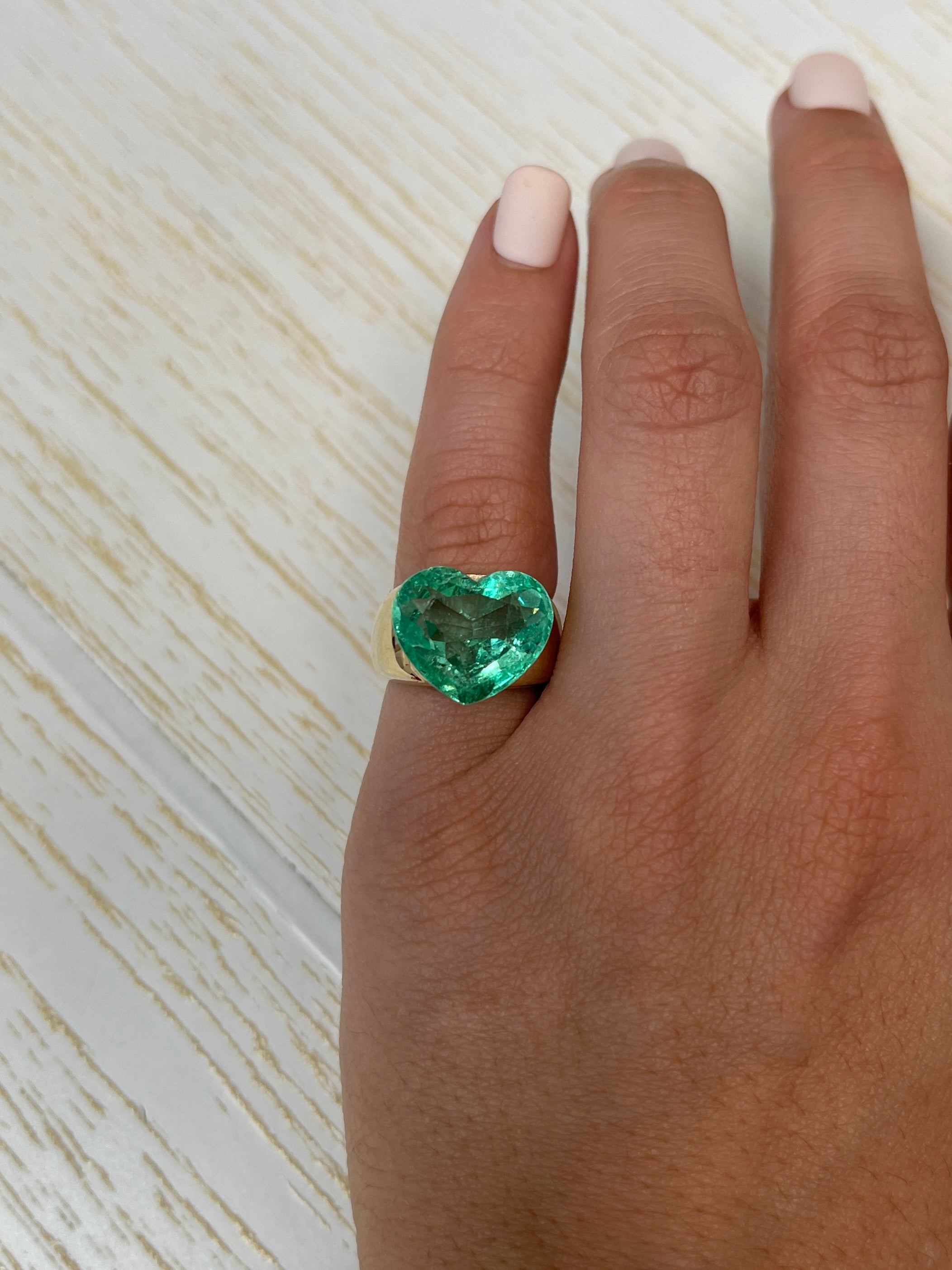 Natural loose Colombian emerald heart cut, 9.84 carats, eye-clean, bubbly appearance, from JR Colombian Emeralds.