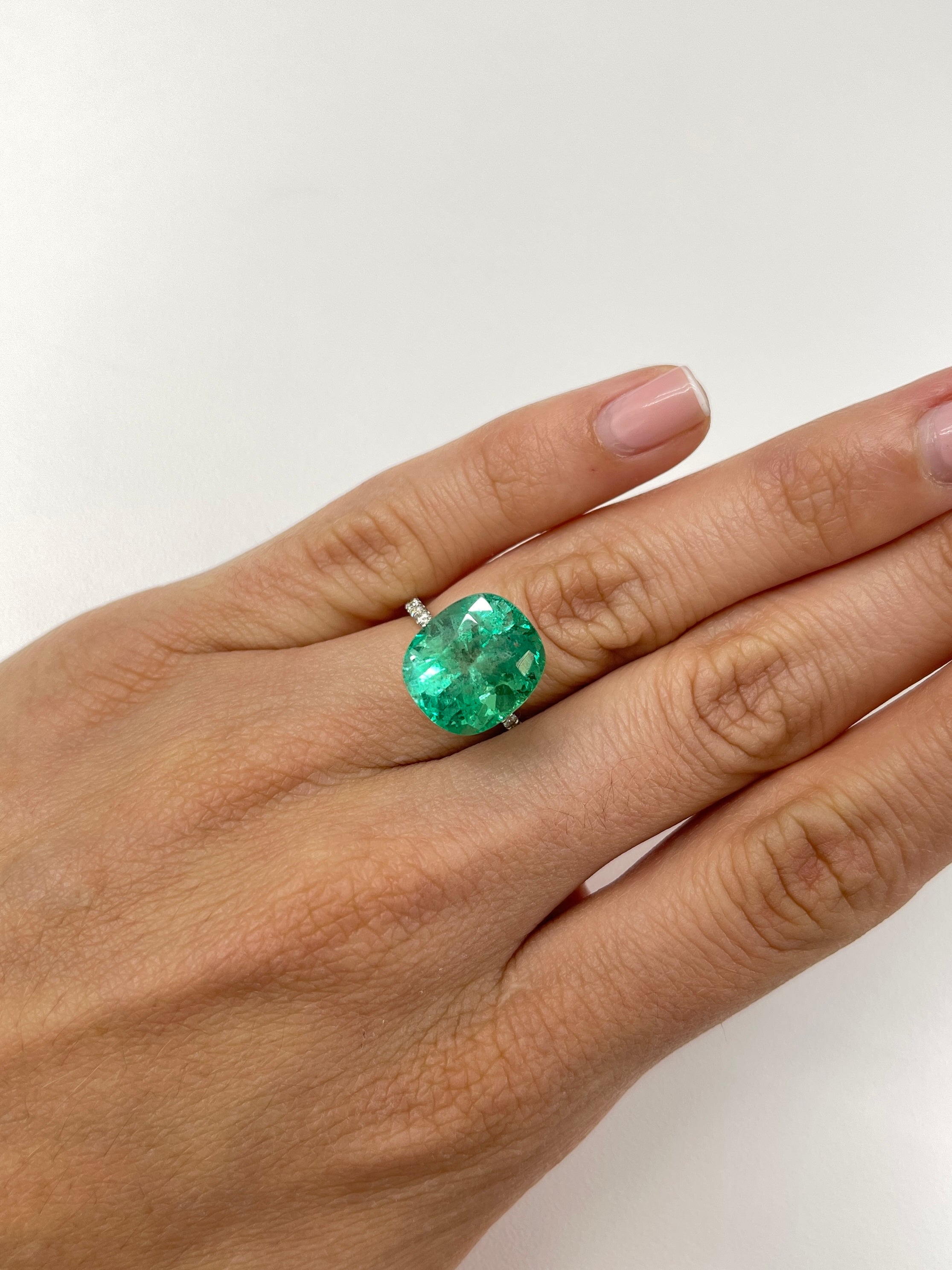 9.89 carat spring green Colombian emerald loose cushion cut gemstone from JR Colombian Emeralds on a white background.